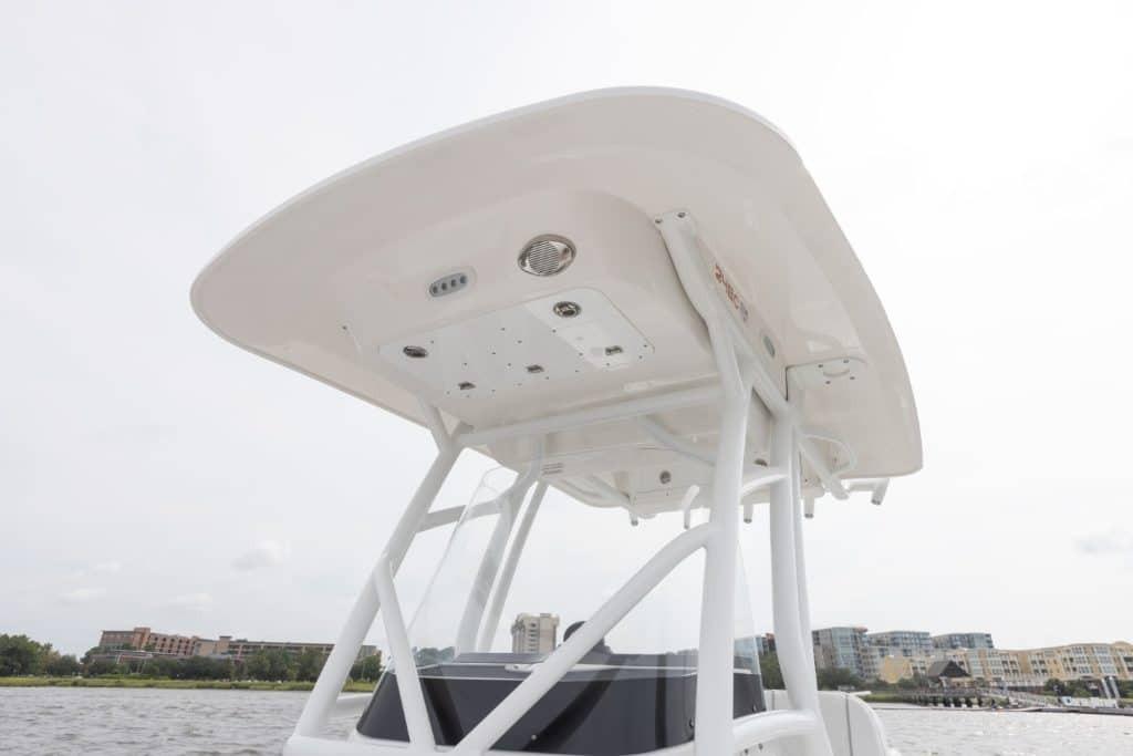 2027 Sea Fox 248 Commander boat's T-top structure against a waterfront cityscape.