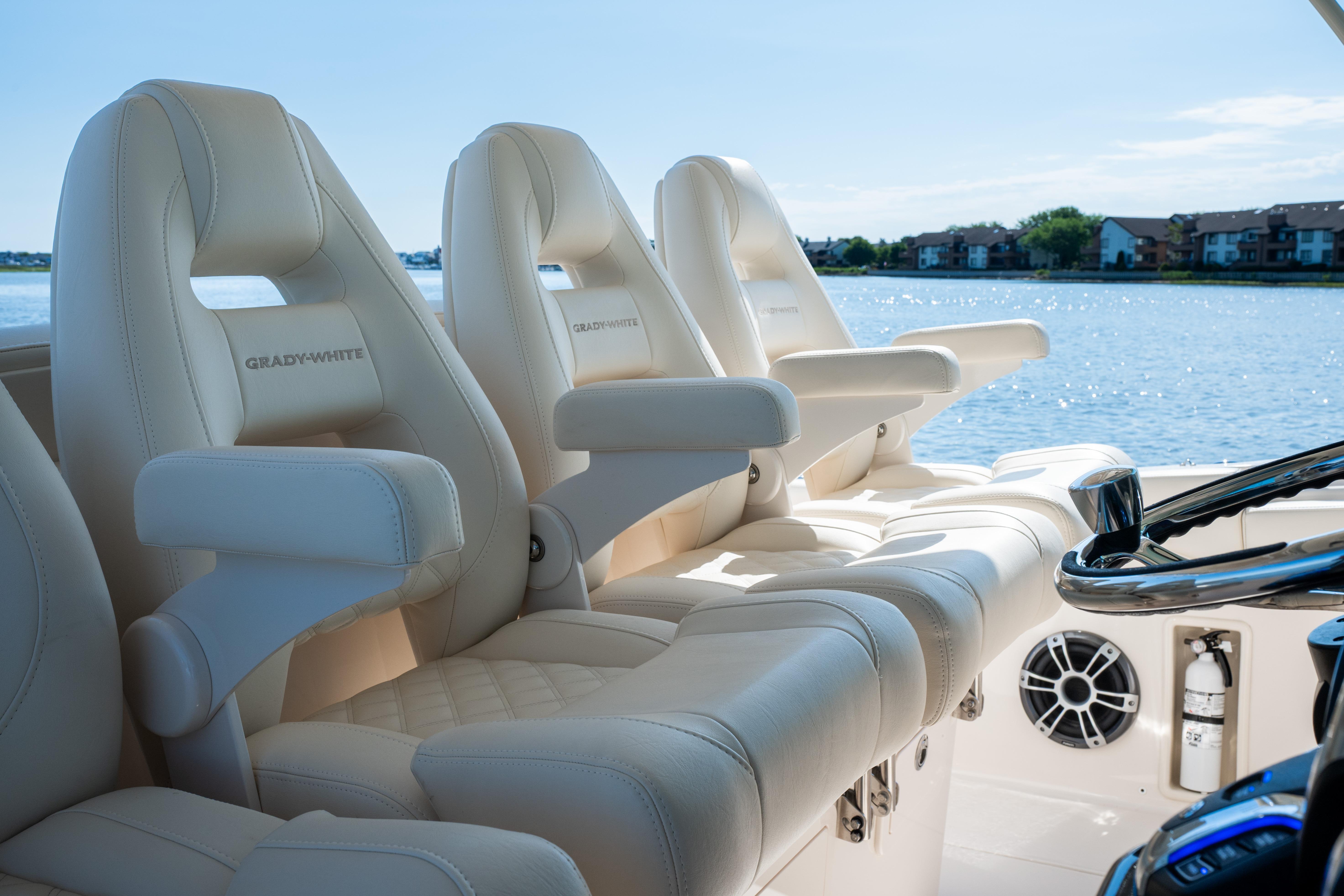 Luxurious seating on 2025 Grady-White Canyon 386 boat, overlooking serene waterfront.