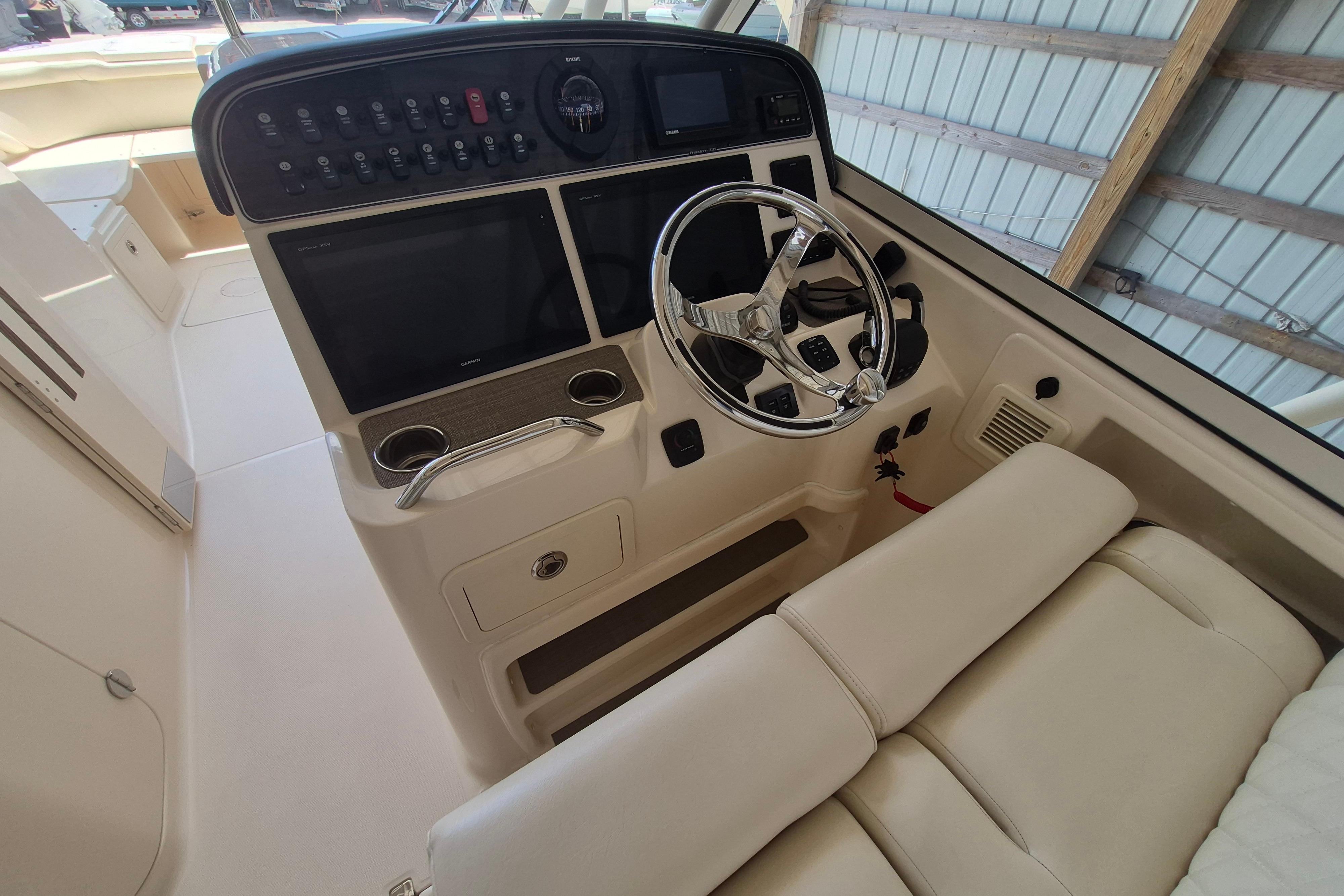 2019 Grady-White Freedom 335 boat cockpit with steering wheel and control panel.