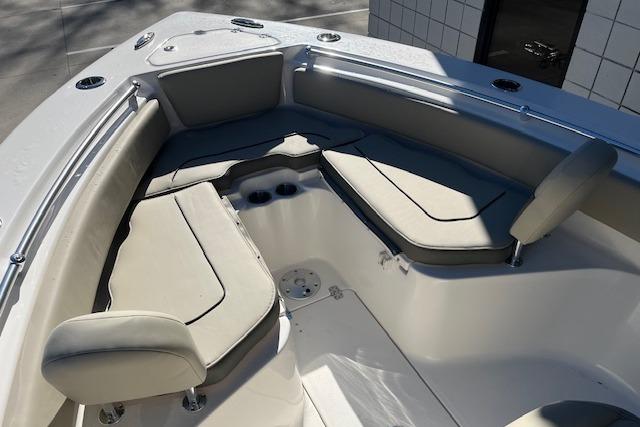 2026 Key West 239 FS boat interior with cushioned seating and cup holders.