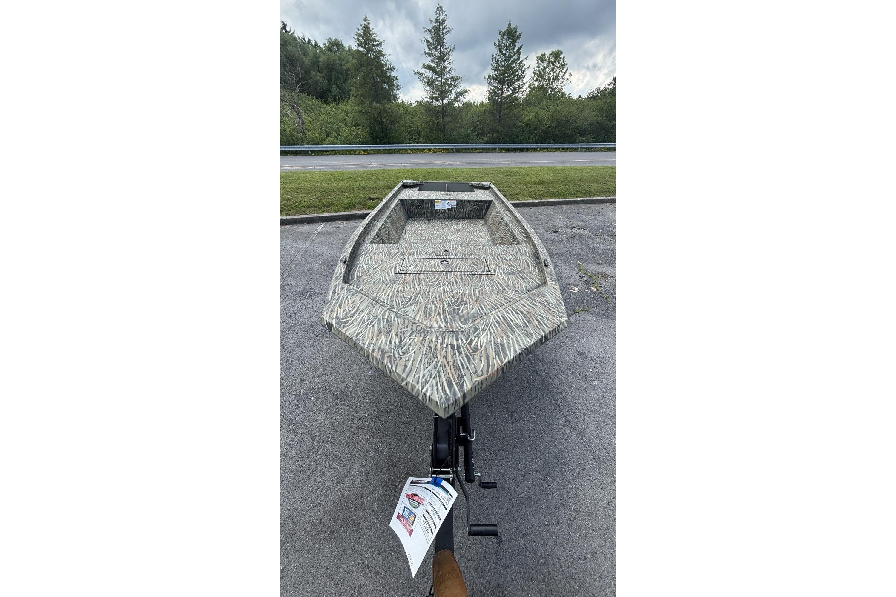 2026 Tracker Grizzly 1648 Utility boat with camouflage design on a trailer.