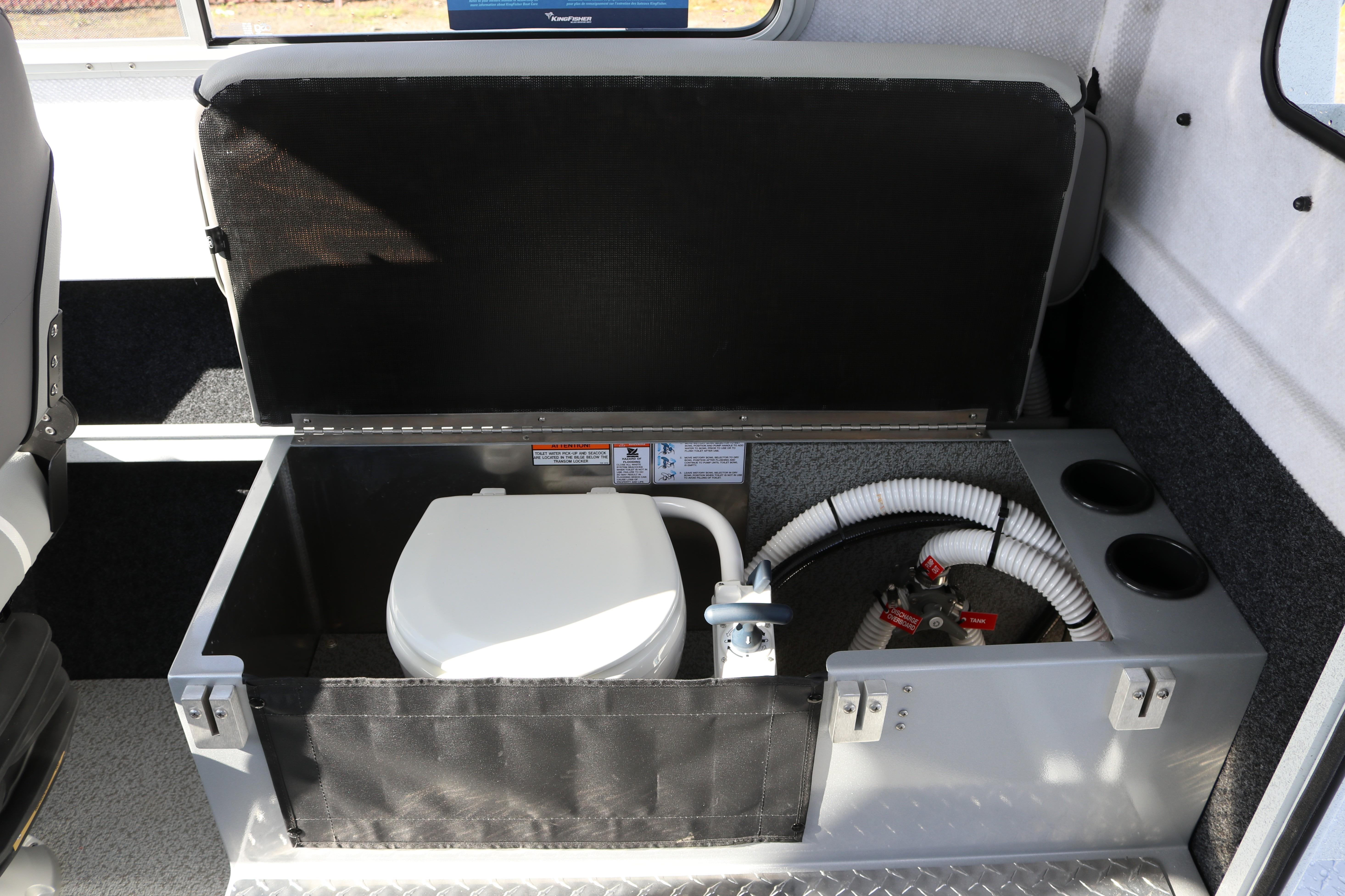 2026 KingFisher 2425 Escape HT boat interior with built-in toilet and plumbing system.