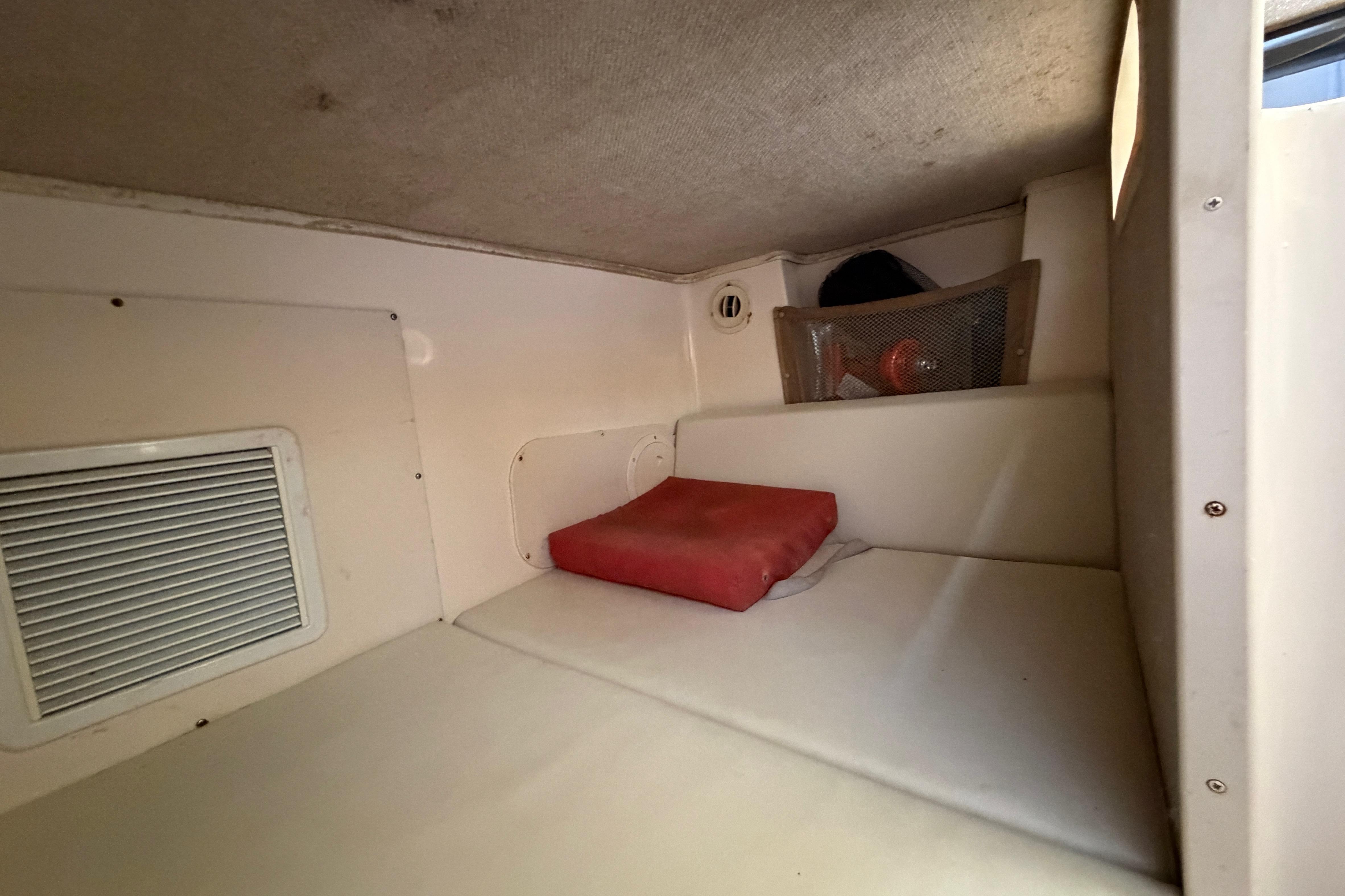 Interior cabin of 2006 Grady-White Sailfish 282 boat with cushion and storage.
