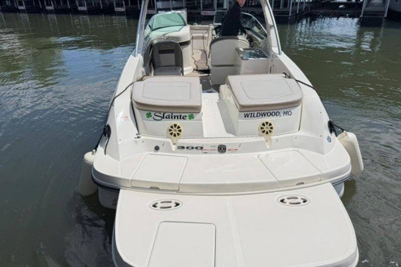 2011 Sea Ray 300 SLX boat docked, rear view with seating and water backdrop.