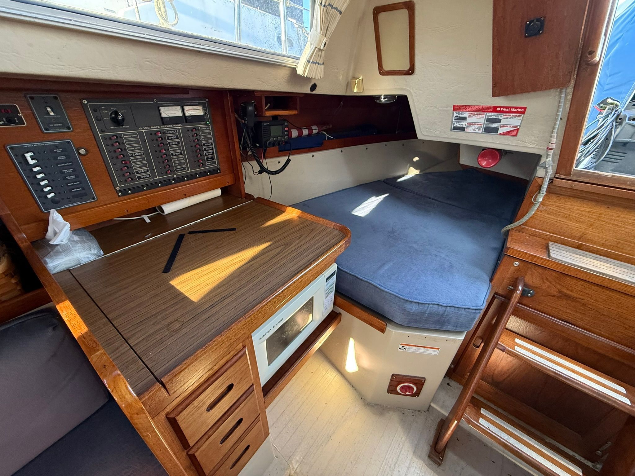 Interior of a 1980 Catalina 38 sailboat with navigation area.