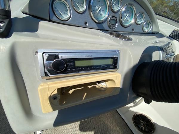 Dashboard of 2005 Bayliner 249 SD boat with stereo and gauges.