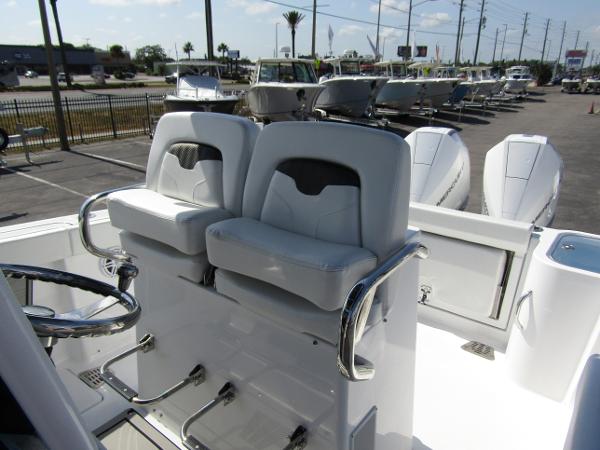 2024 Wellcraft 263 Fisherman boat with dual captain's chairs and steering wheel.