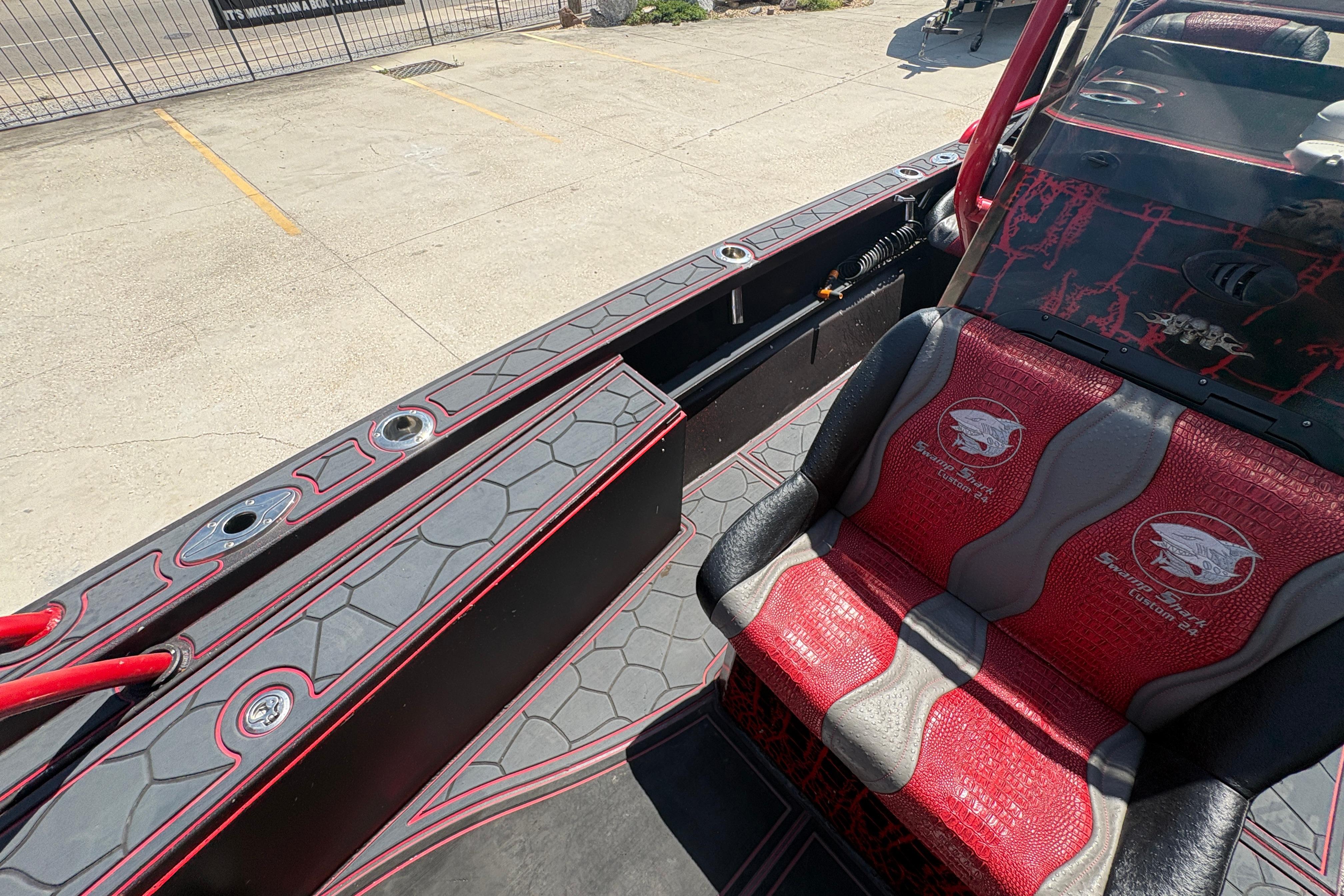 Custom 2018 Swamp Shark 24' boat interior with red and gray seating and deck design.