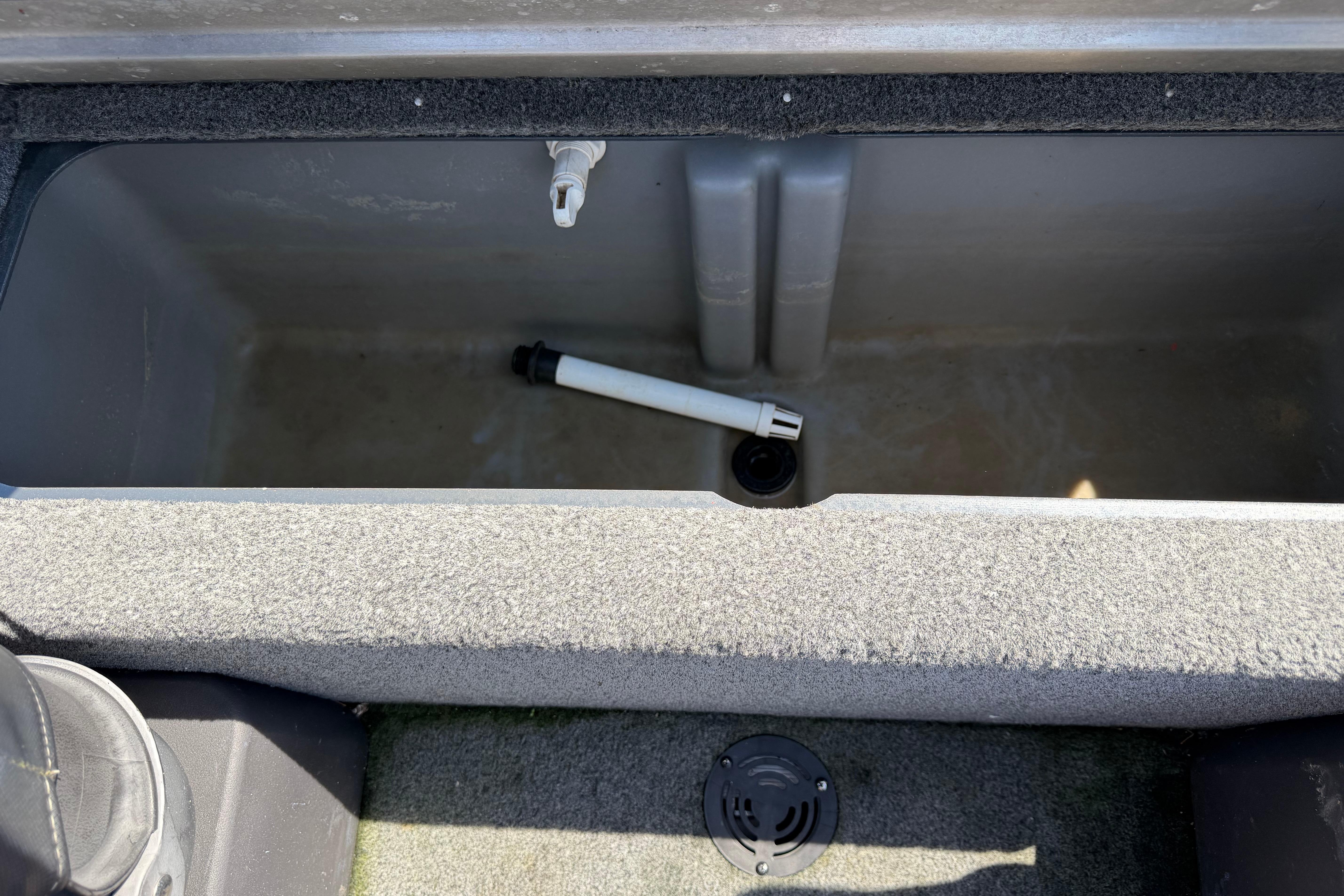 2019 Tracker Pro Team 175 TF boat storage compartment with drain pipe.