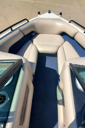 2000 Calabria Sport Comp XTS boat interior with beige seating and blue flooring.