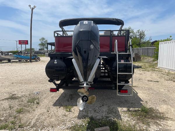 2023 Regency 250 DL3 pontoon boat, rear view with outboard motor and ladder.