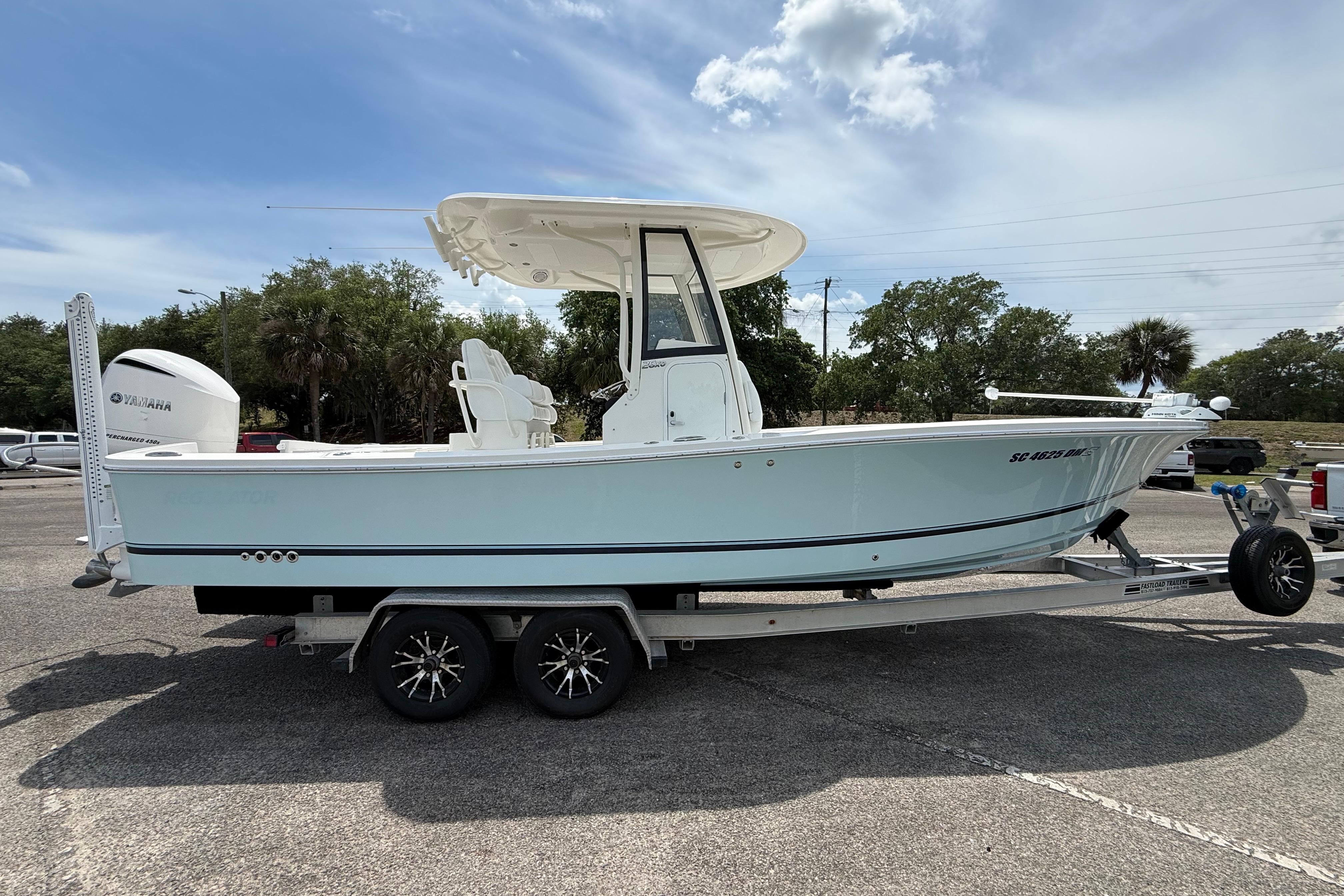 2019 Regulator 26XO boat on trailer, side view, outdoors, with Yamaha engine.