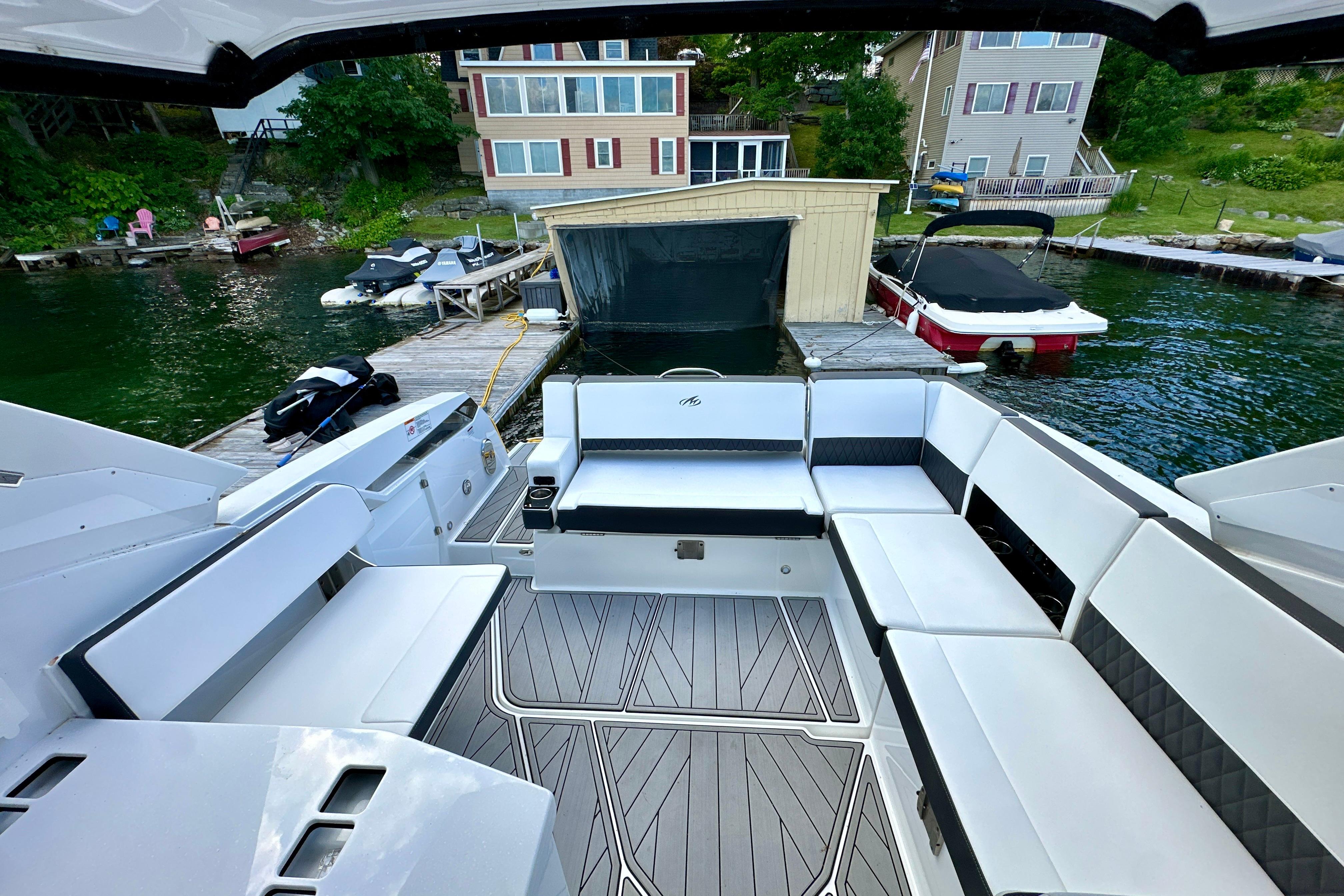 2022 Monterey 378SS Super Sport boat interior with spacious seating at a lakeside dock.