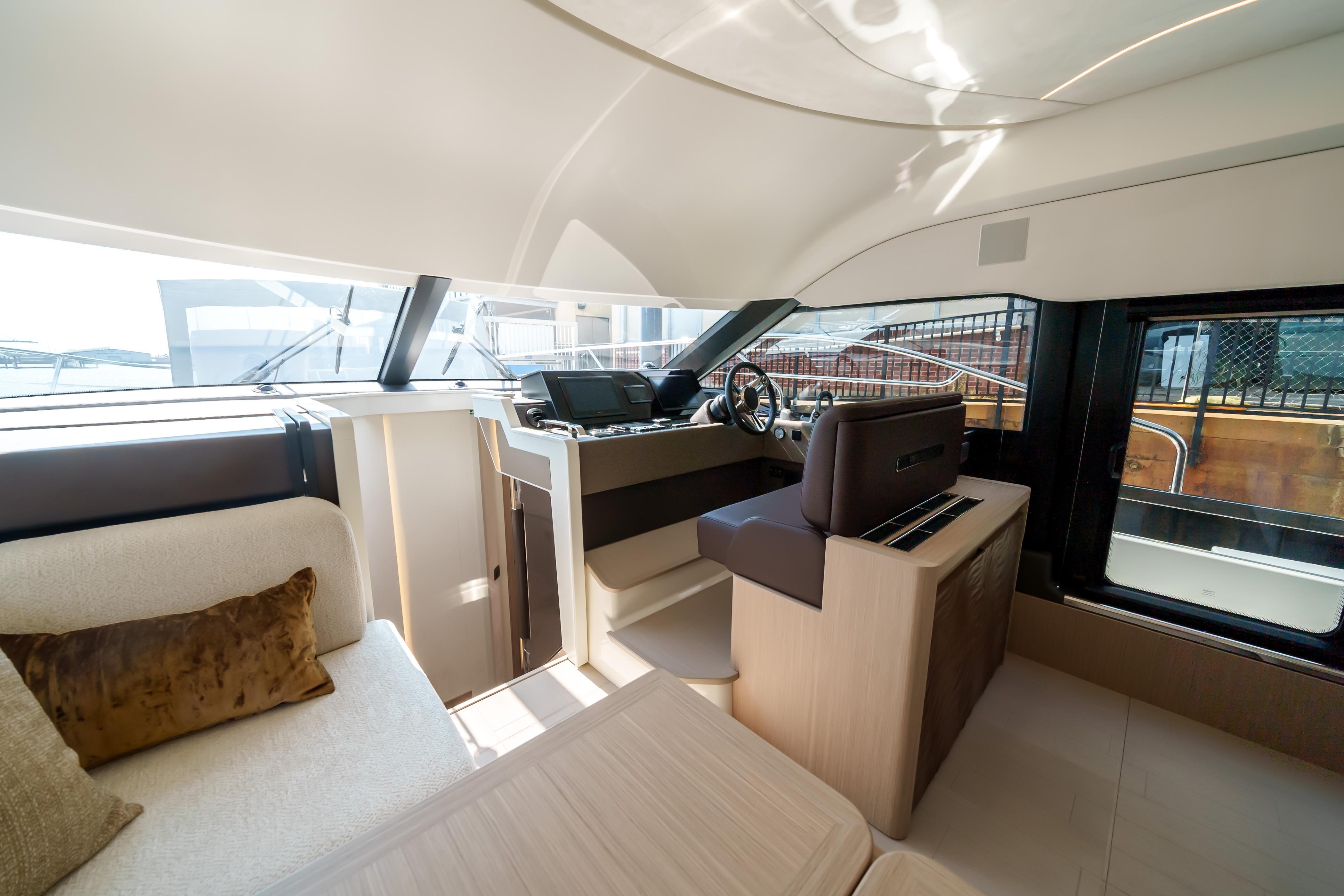 Luxurious interior of 2025 Prestige F4.9 yacht with modern helm and seating area.