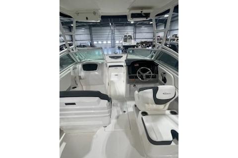 2022 Robalo R247 Dual Console boat interior with steering wheel and seating.
