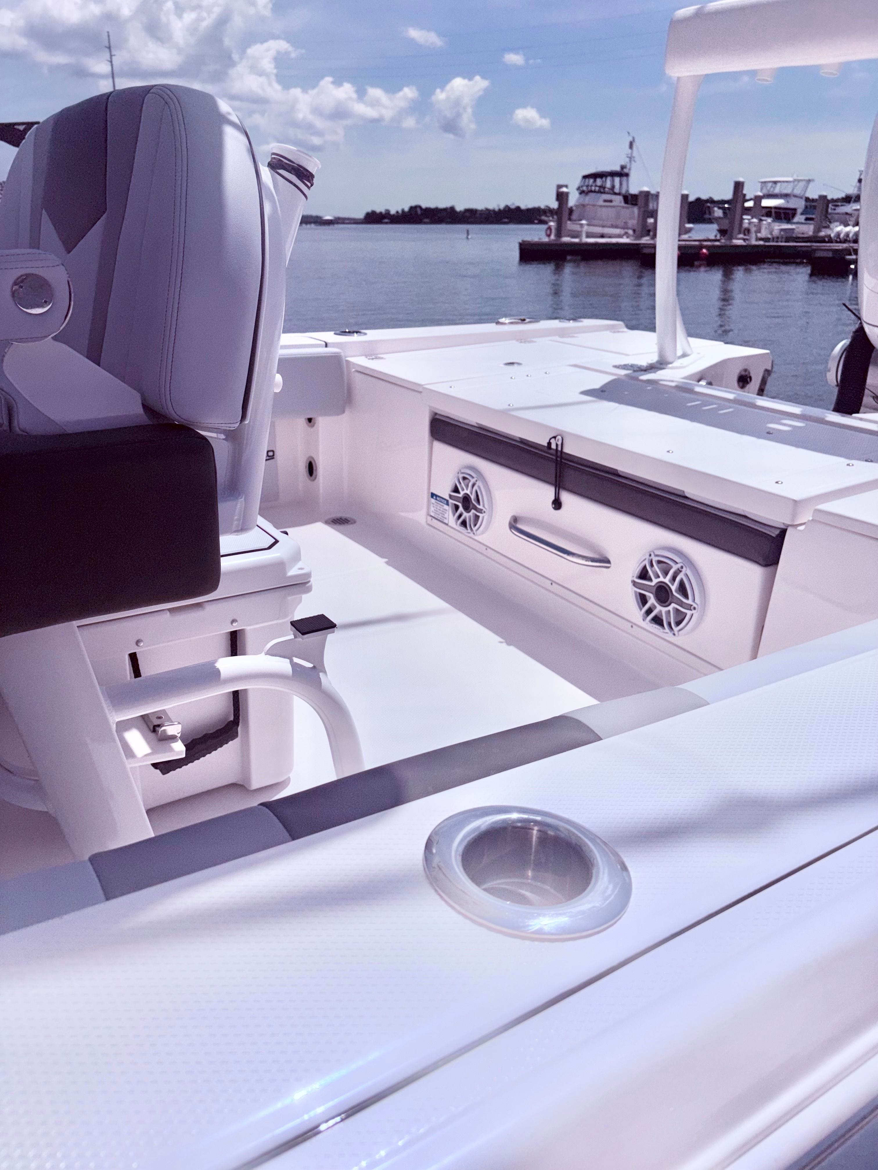 Interior of a 2025 Robalo 266 Cayman boat by the water.