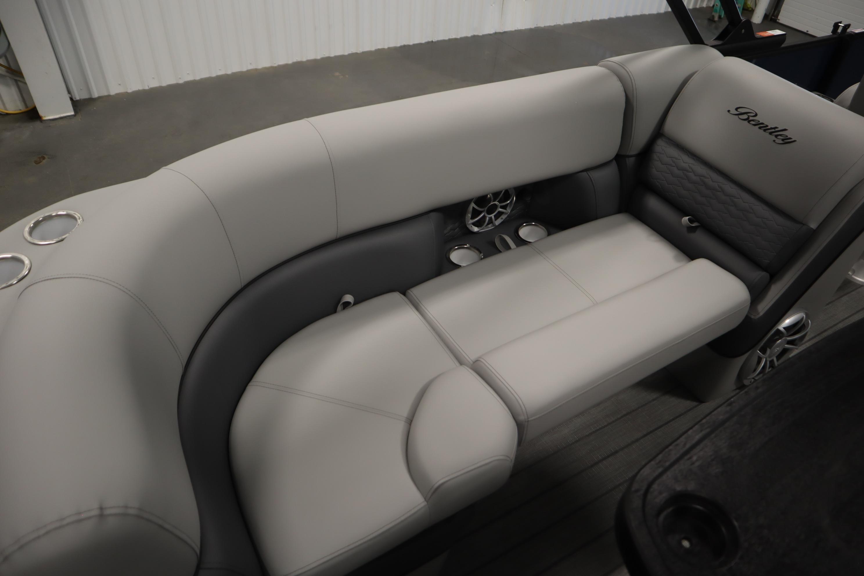 Luxurious seating in 2025 Bentley Pontoons Elite 253 Admiral Tri-toon, featuring cup holders and speakers.