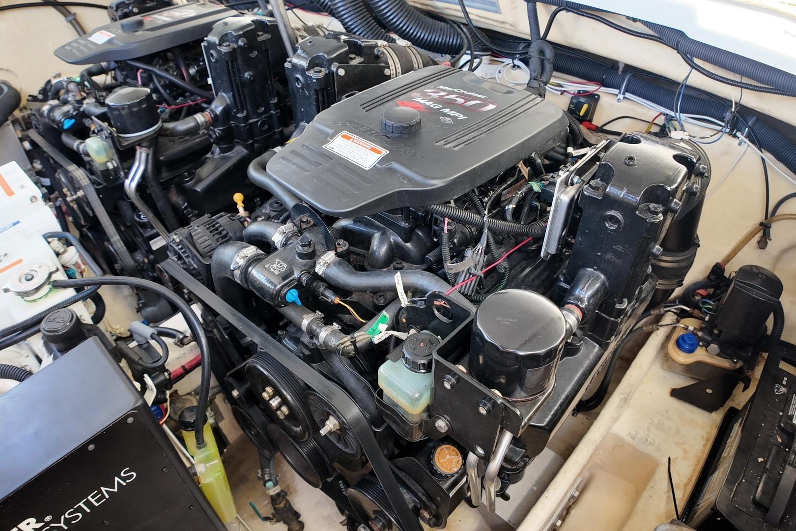 Engine compartment of a 2007 Formula 330 Sun Sport boat, showcasing dual engines and components.