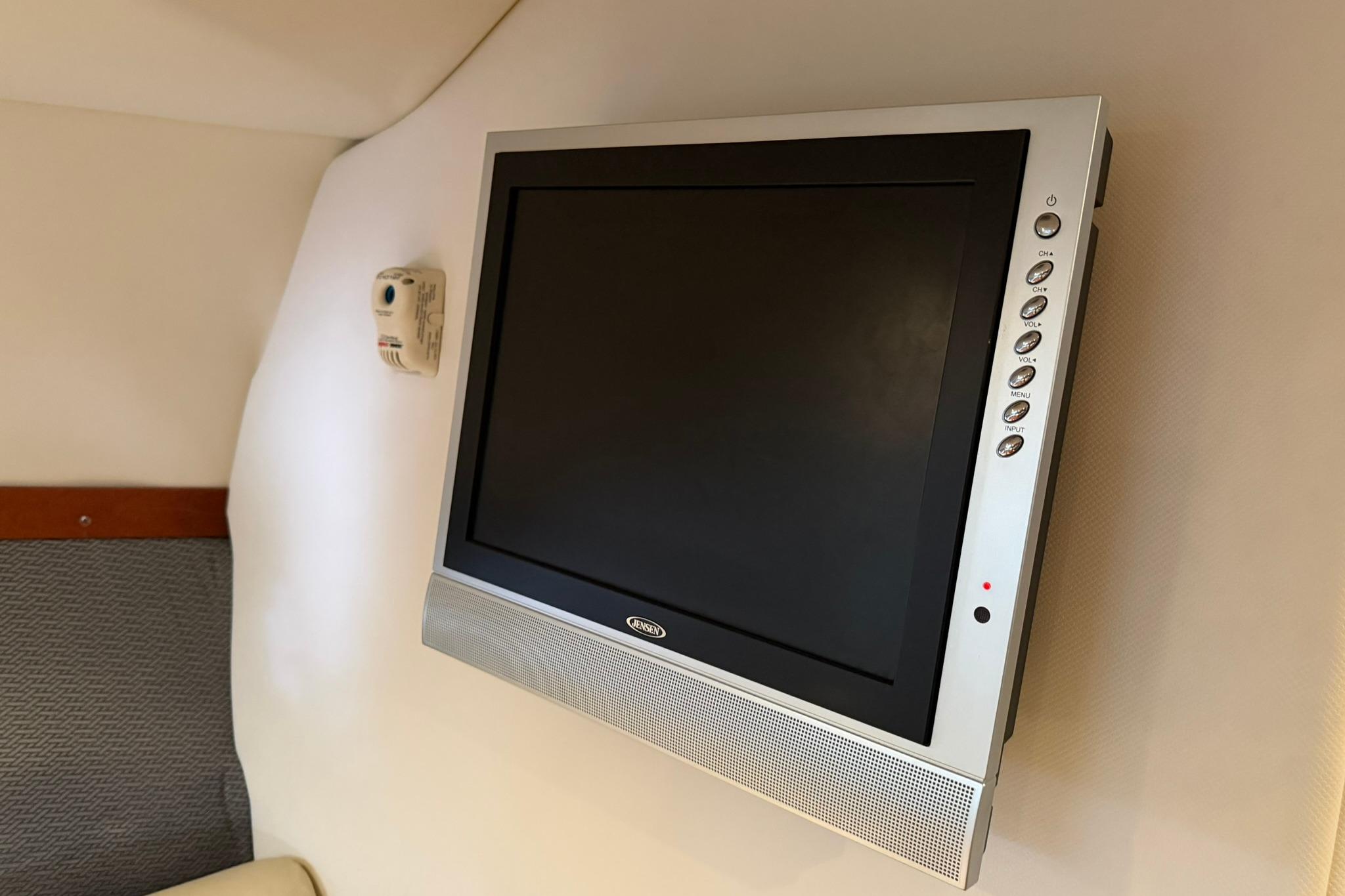 Wall-mounted TV in 2008 Four Winns V248 boat interior.
