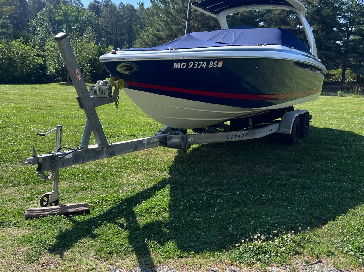 2003 Cobalt Colbalt 262 boat on trailer in grassy area.