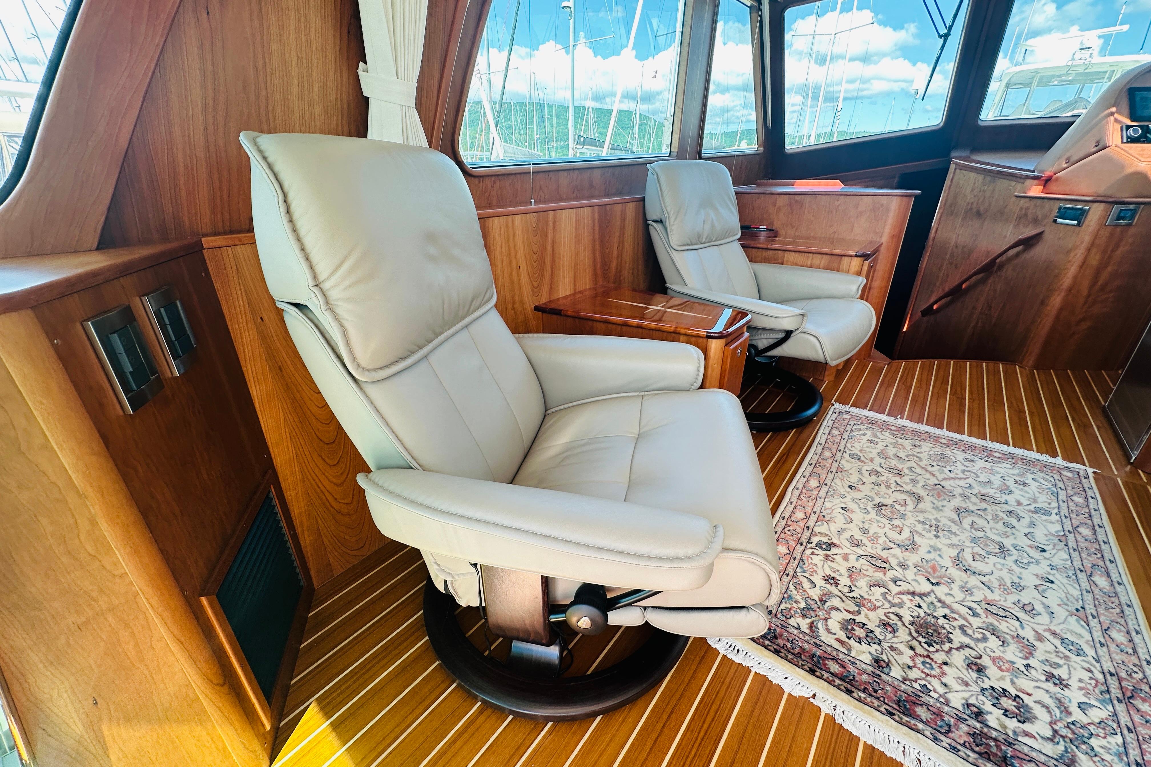 Luxurious interior of 2025 Sabre 48 Salon Express with leather seating and elegant wood finish.