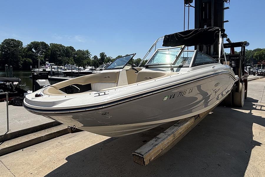 2018 Sea Ray SPX 190 boat on a dock lift, sunny day, marina background.