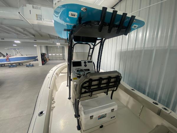 2024 Key West 219 FS boat interior with console and seating in a showroom.