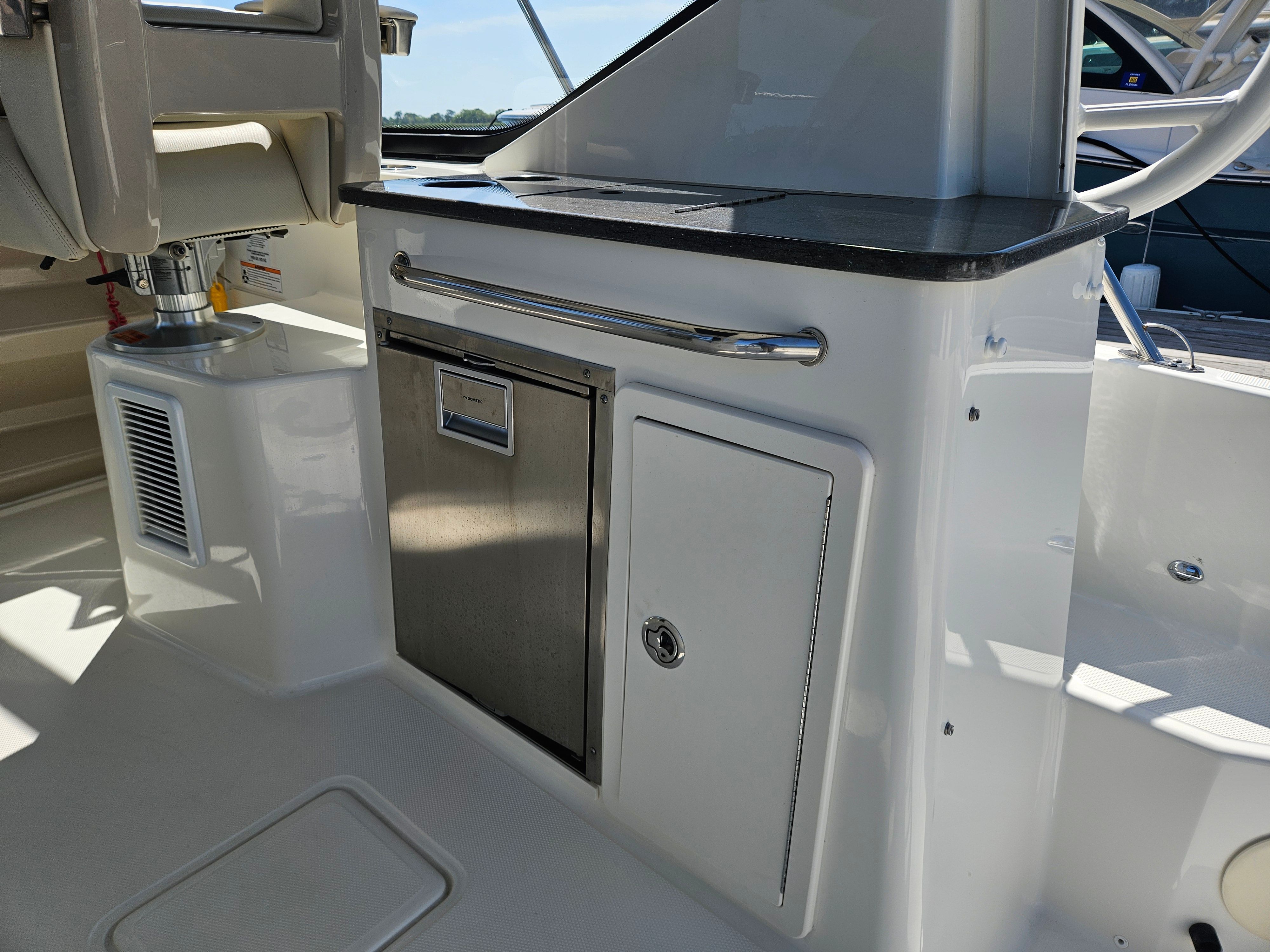 The 2023 Boston Whaler 325 Conquest features a sleek galley area with stainless steel elements.