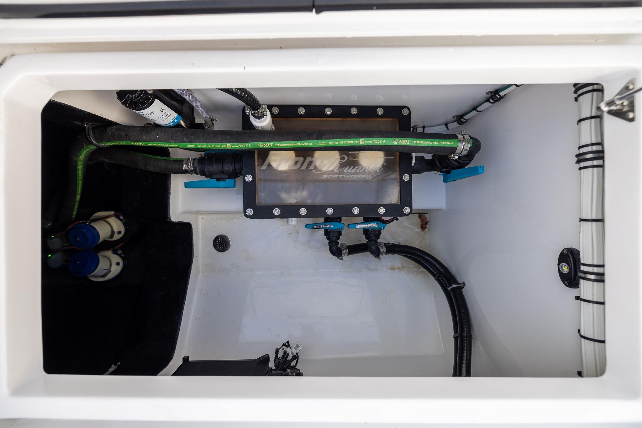 Engine compartment of 2026 Front Runner 37 Catamaran, showcasing wiring and plumbing details.