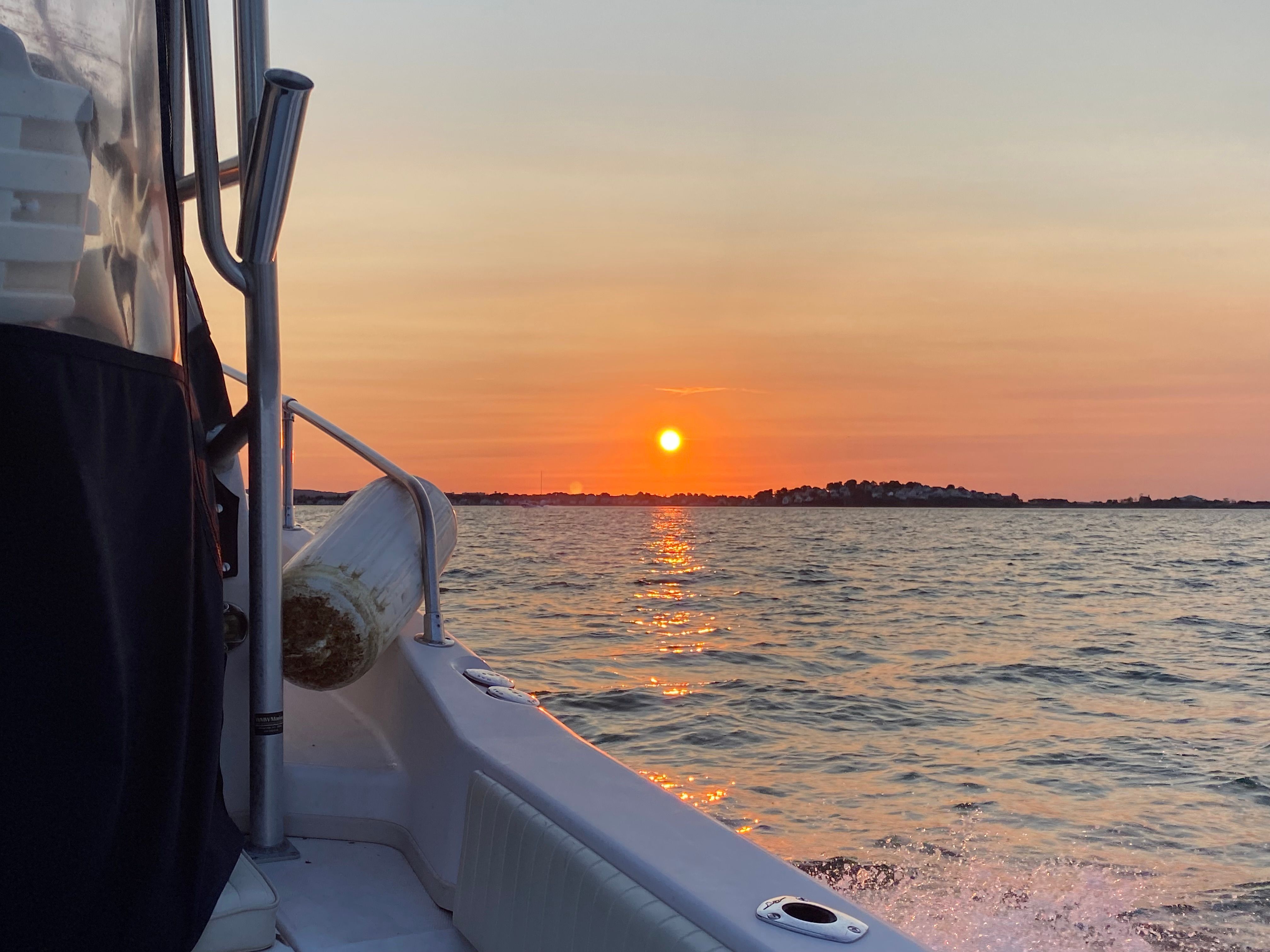 A 2003 Grady-White Sailfish 282 cruising on the water at sunset.