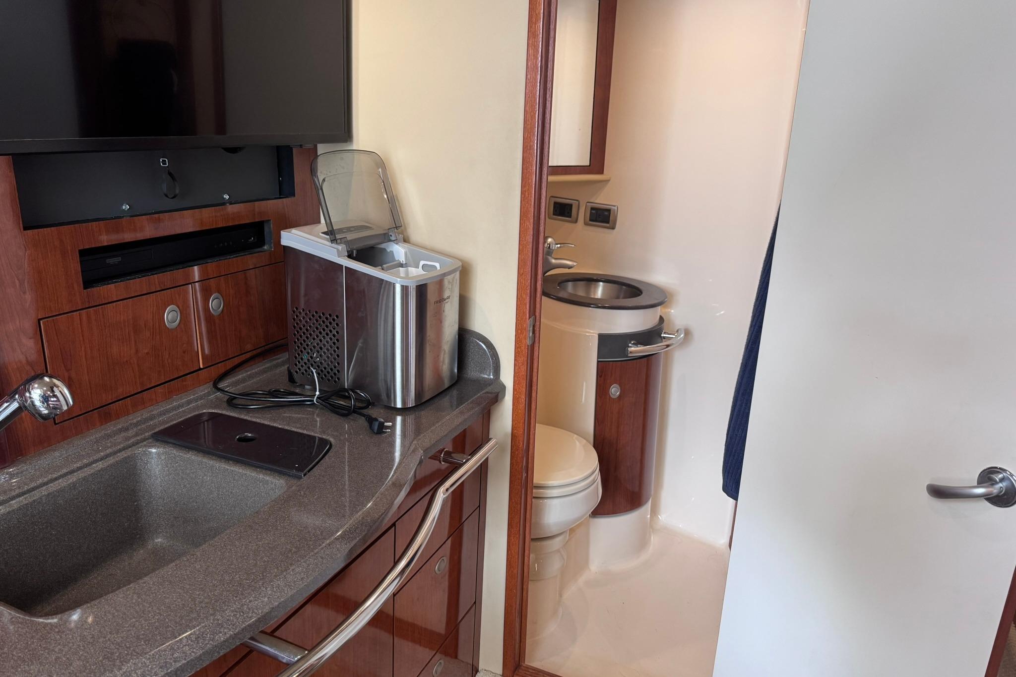 Interior of 2004 Sea Ray 390 Sundancer yacht with kitchenette and bathroom.