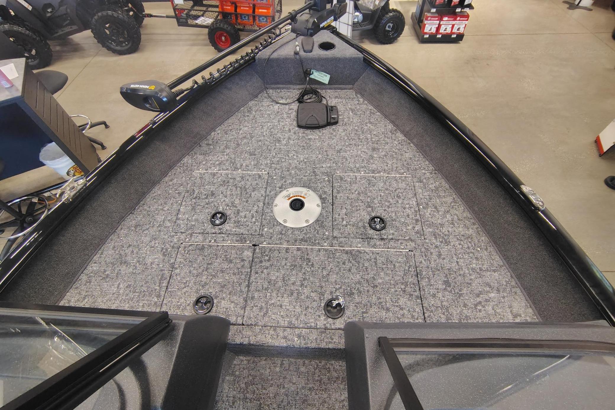 2026 Tracker Pro Guide V-16 WT boat interior with carpeted deck and storage compartments.