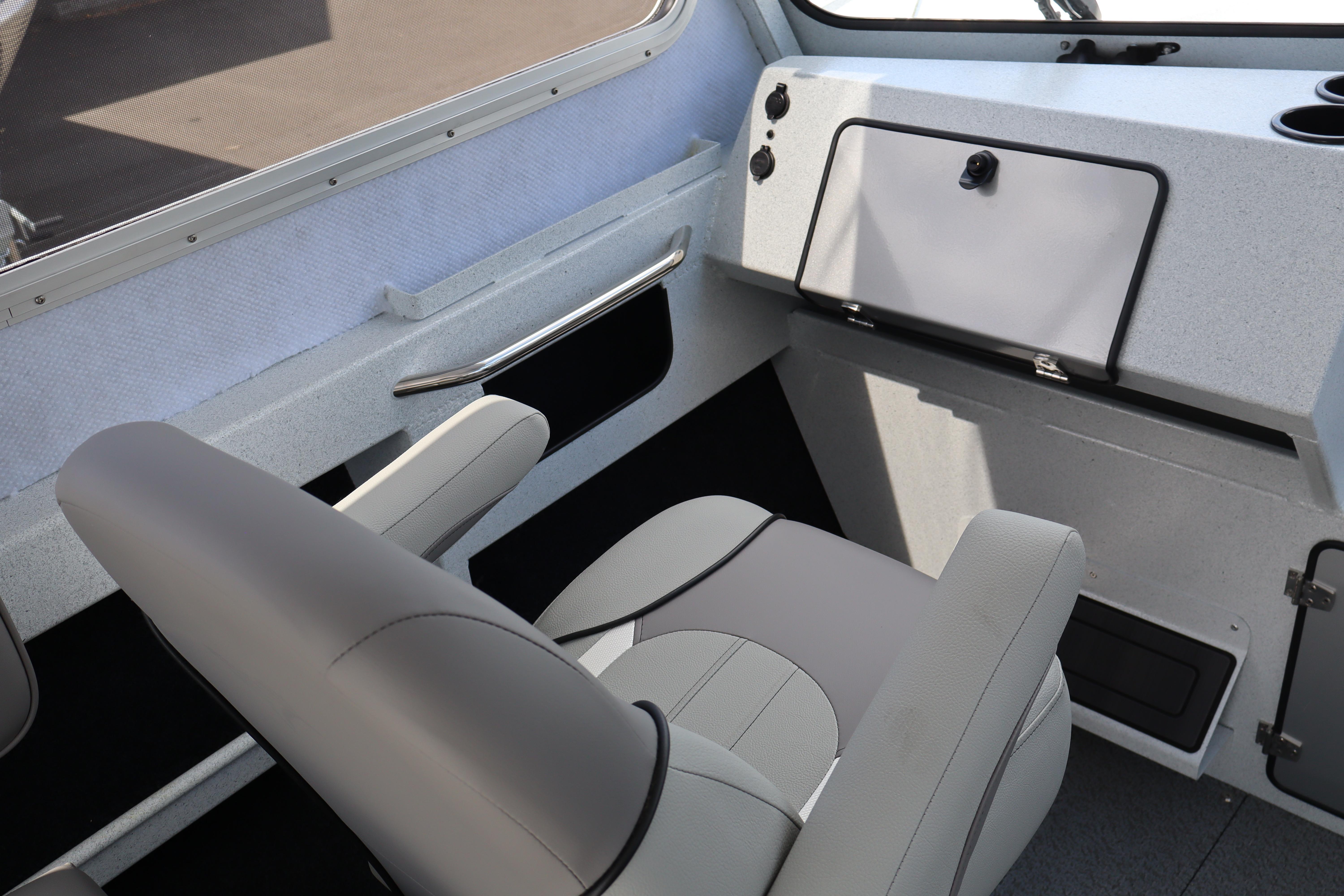 Interior of 2026 KingFisher 2425 Escape HT boat, featuring modern seating and dashboard.