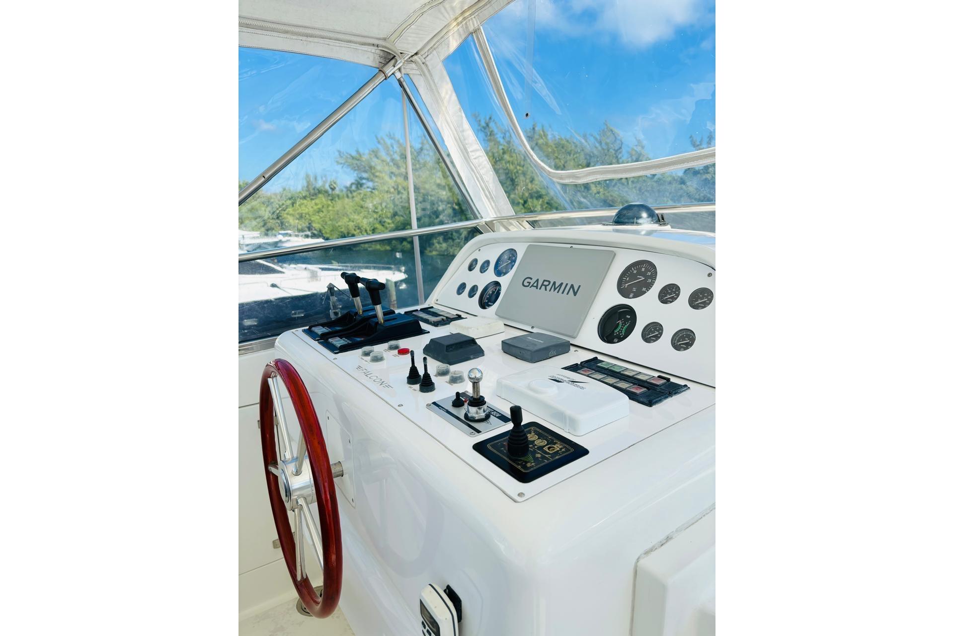 Cockpit of a 2000 Falcon 100 yacht with Garmin navigation system and controls.