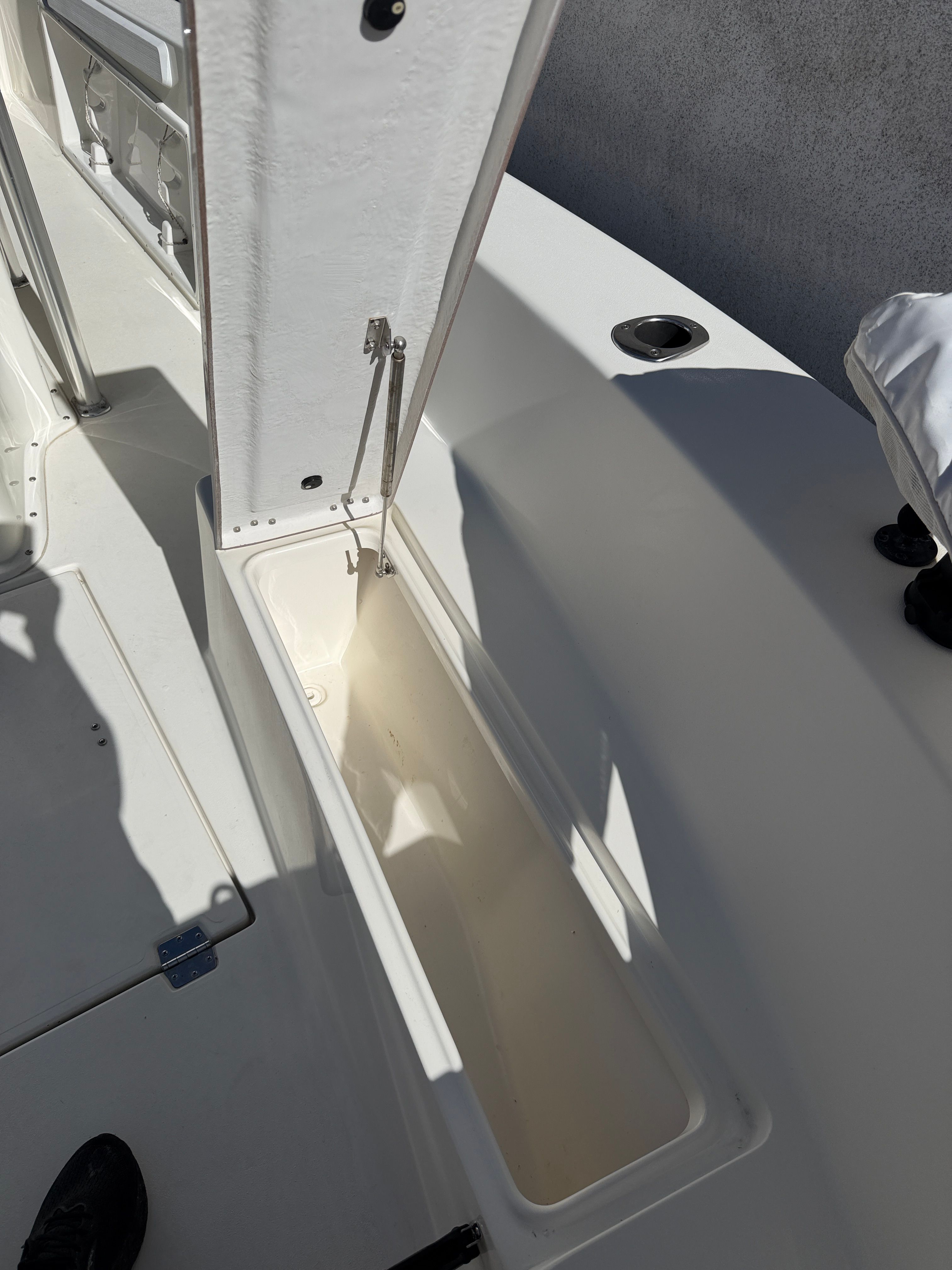 Open storage compartment on a 2021 KenCraft Challenger boat.