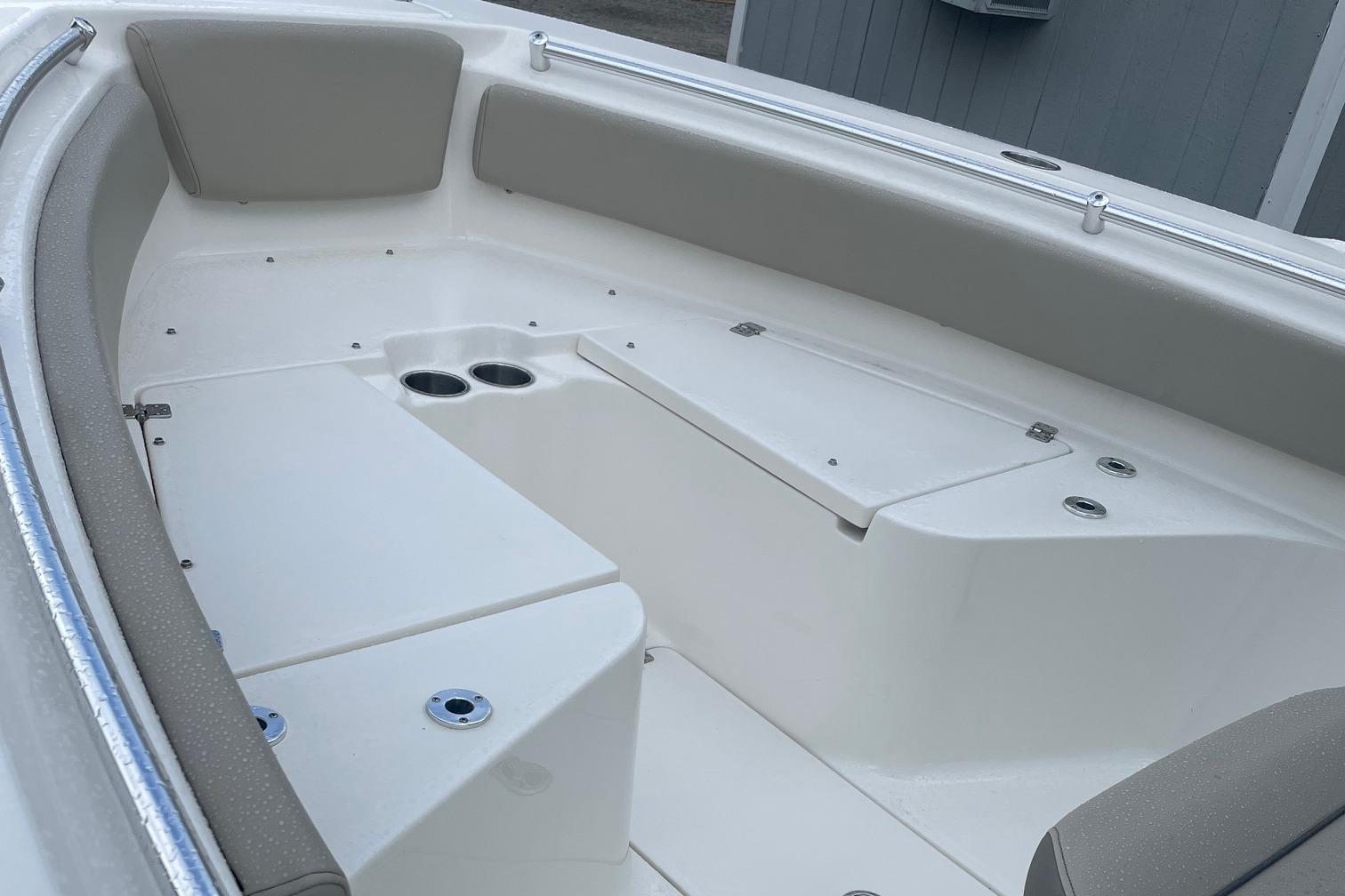 2024 Key West 239 FS boat interior with cushioned seating and cup holders.