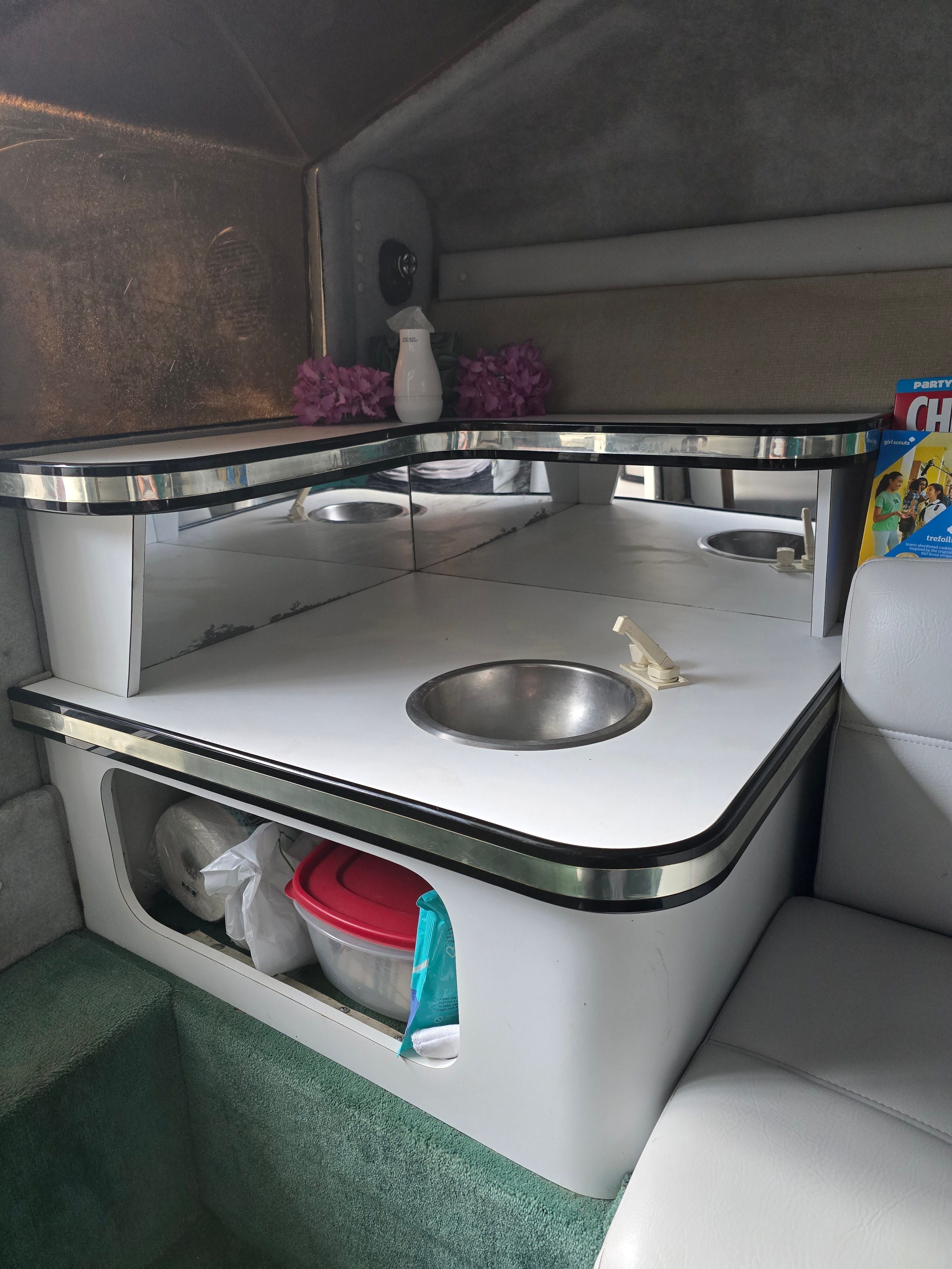 Interior of a 1989 Baja 280 Sport with sink and storage.