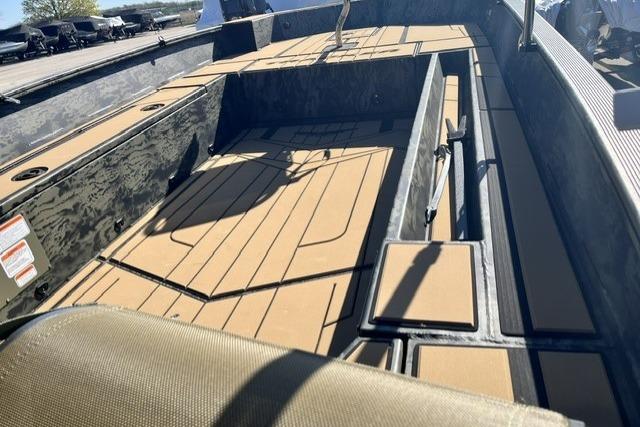 2026 Tracker Grizzly 1756 T Marsh boat interior with tan decking and storage compartments.