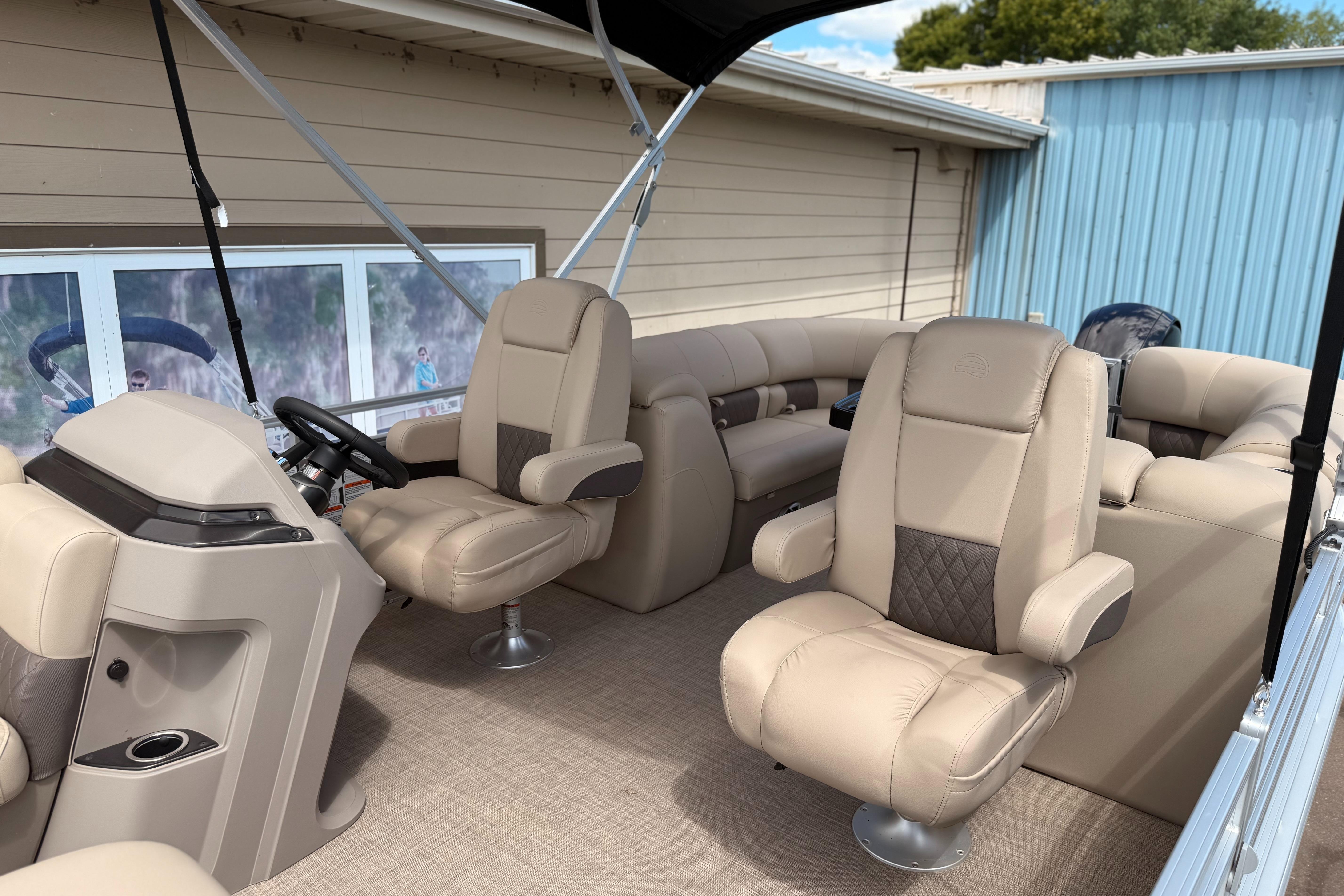 2024 Sun Tracker Party Barge 24 DLX interior with plush seating and modern helm.