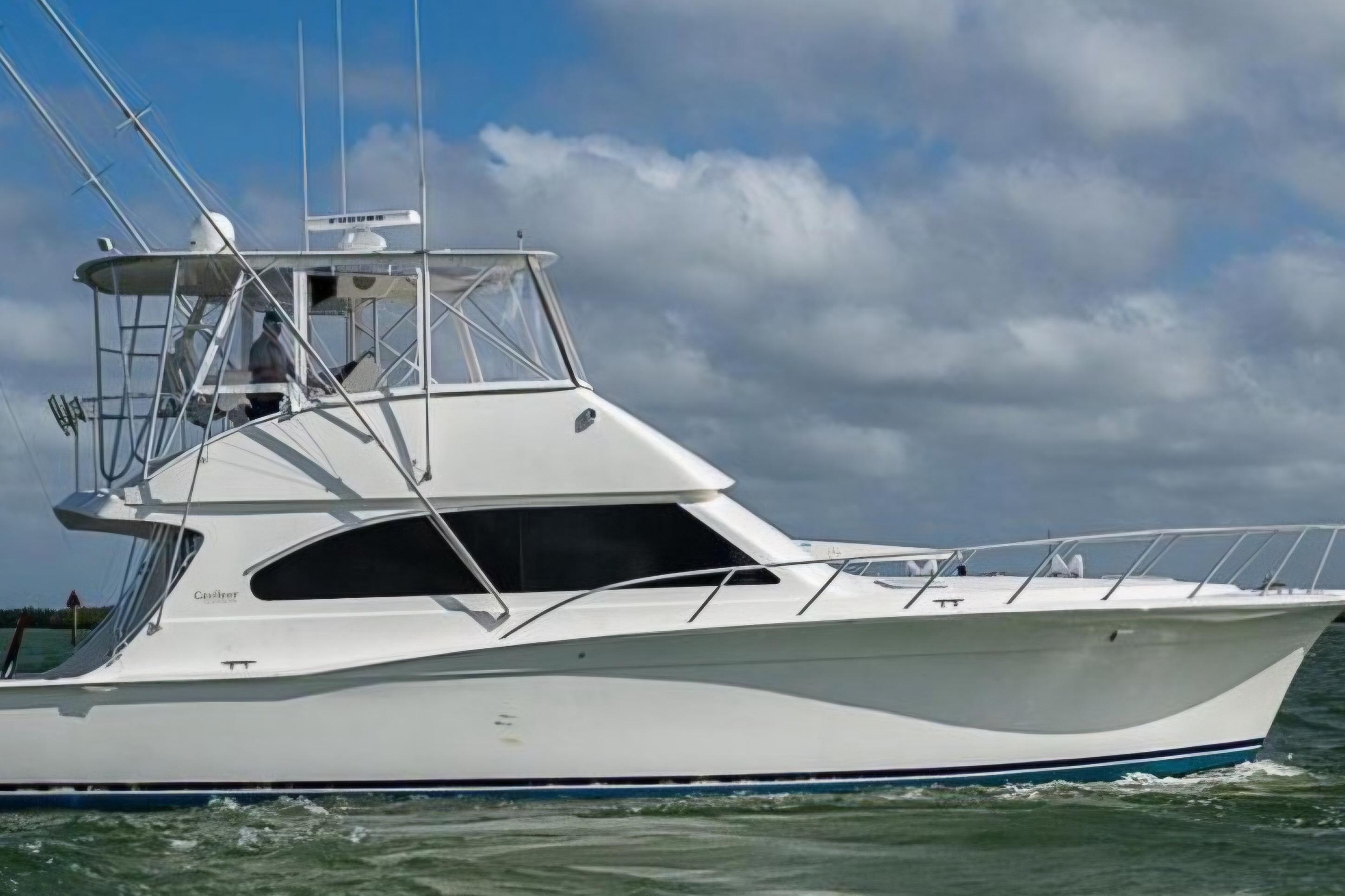 2001 Cavileer 53 Convertible yacht cruising on open water under cloudy skies.