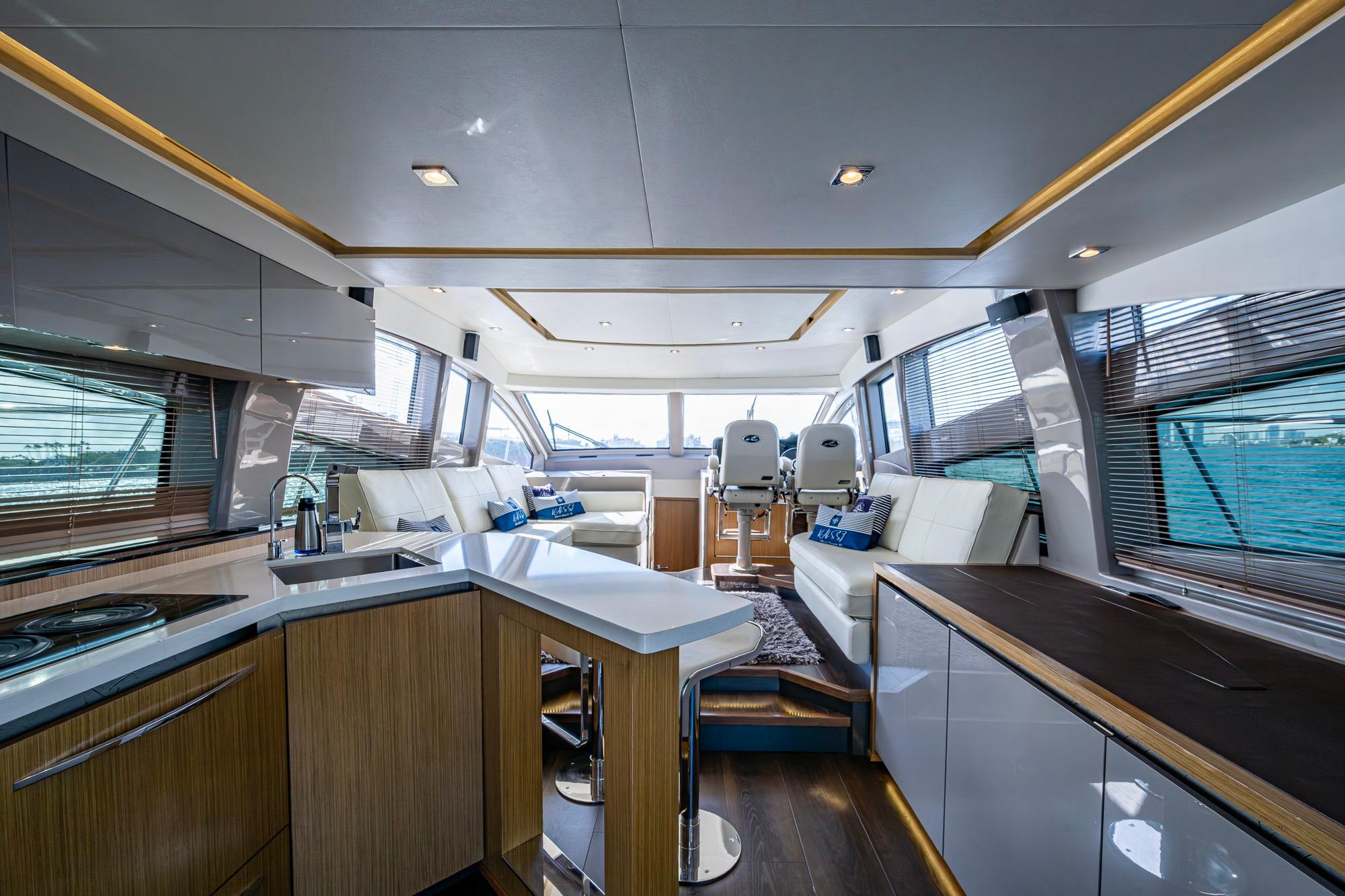 Luxurious interior of 2018 Sea Ray L550 Fly yacht with modern kitchen and seating area.