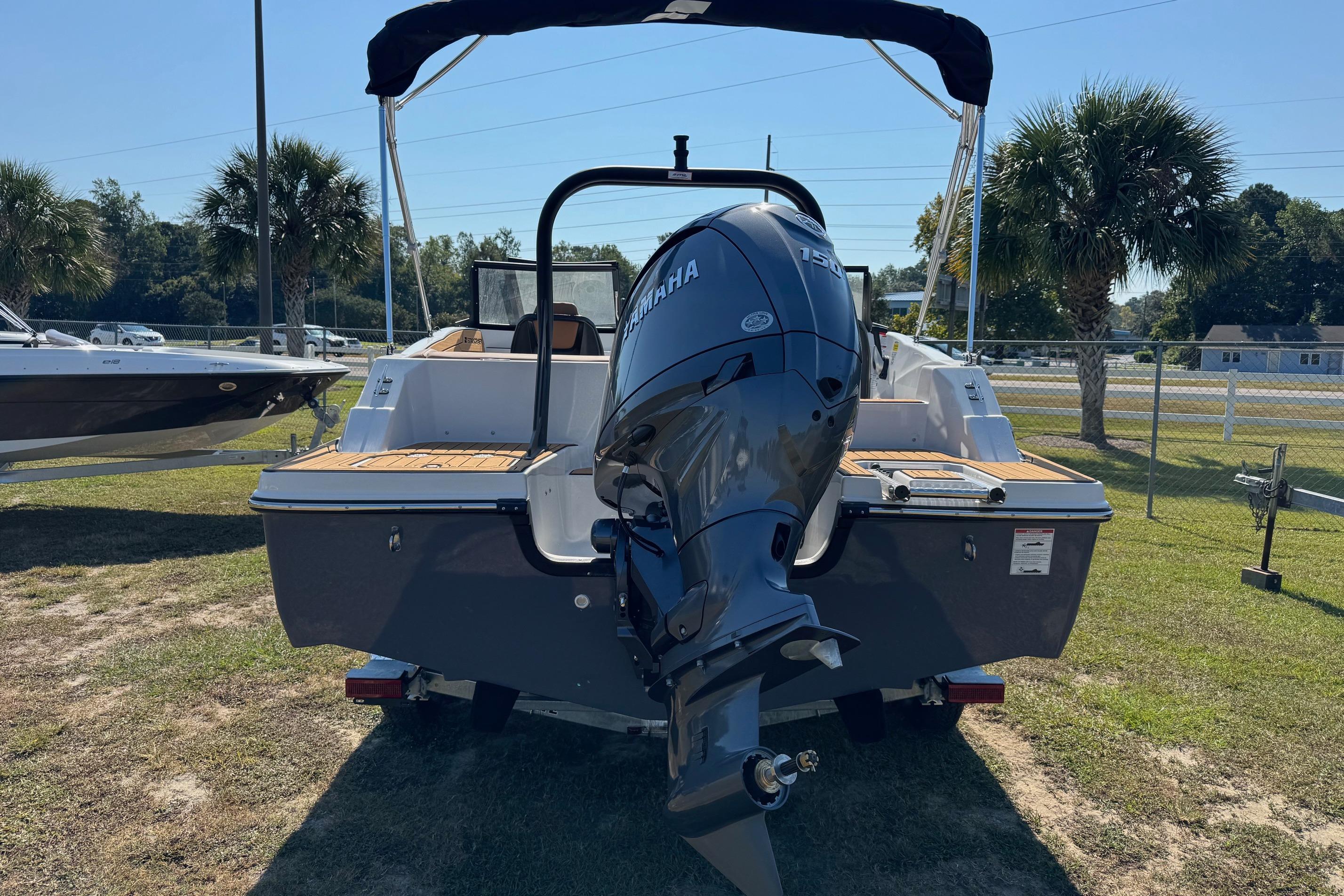 2026 Starcraft SVX 190 OB boat with Yamaha outboard motor, parked on grass.