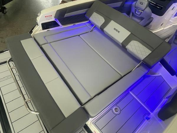 2025 Chaparral 267 SSX boat interior with gray seating and blue LED lighting.