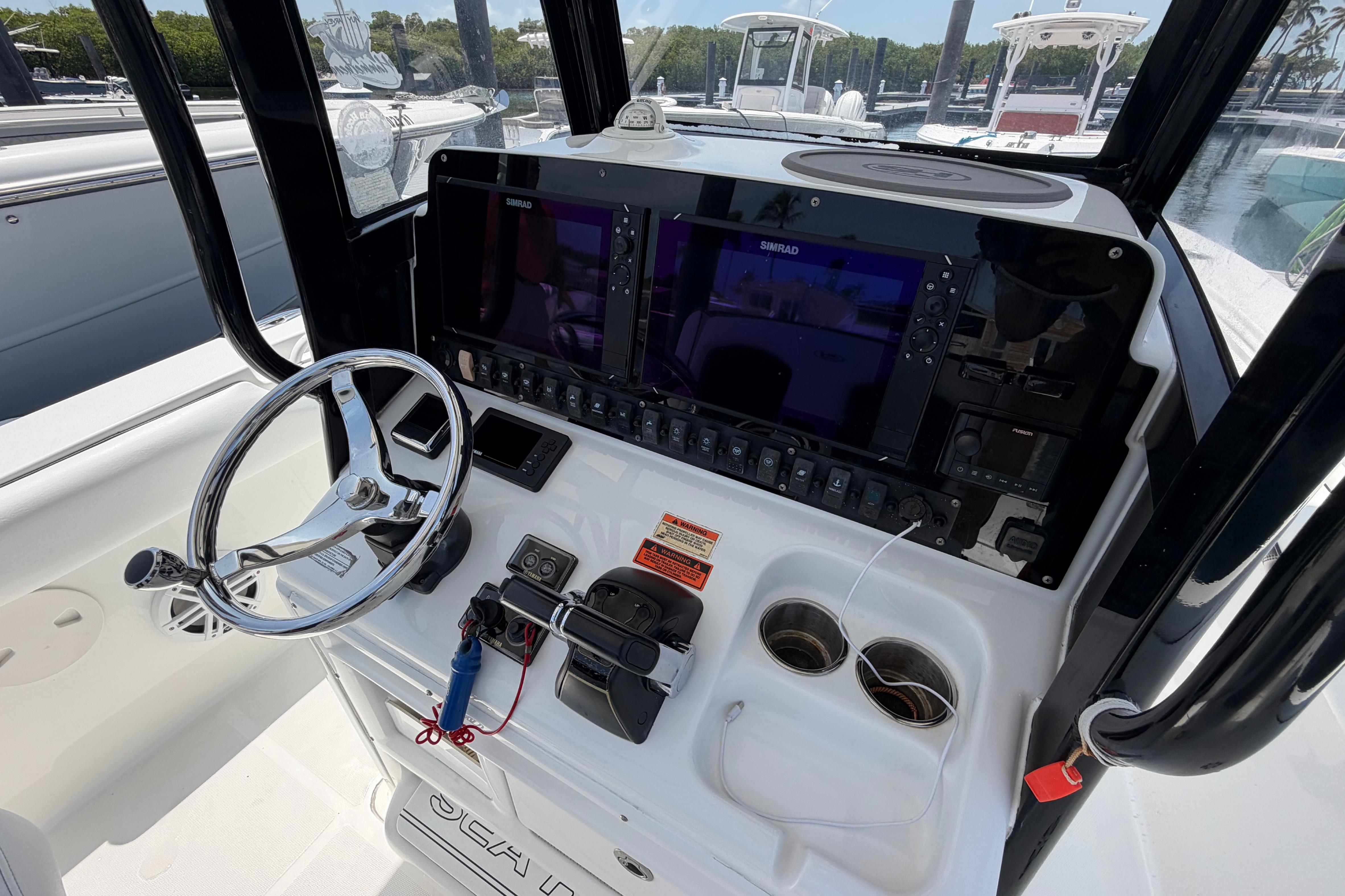 2019 Sea Hunt Gamefish 27 Coffin Box boat console with steering wheel and navigation system.