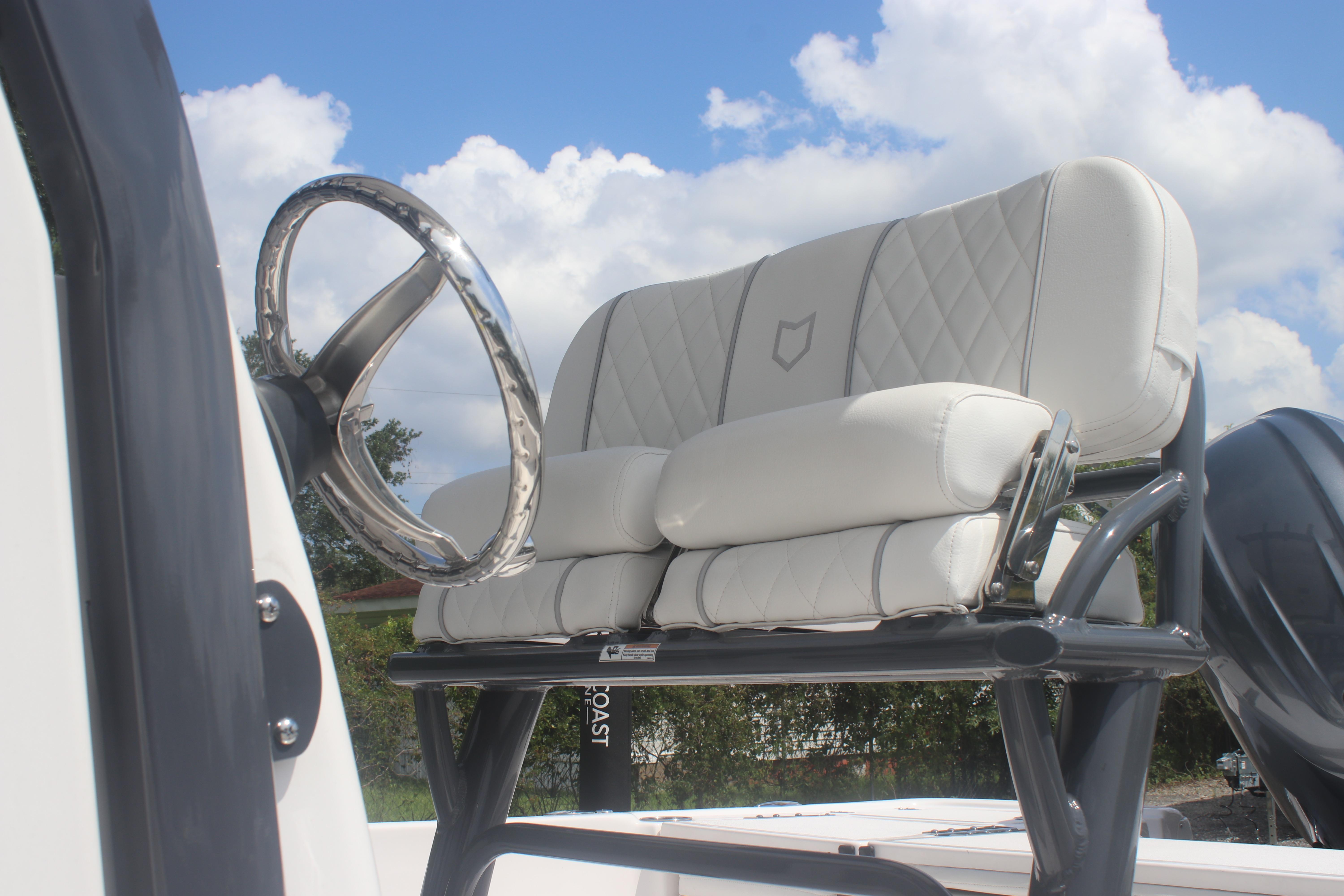 2025 Sea Fox 231 Bay Fox boat with plush seating and sleek steering wheel.