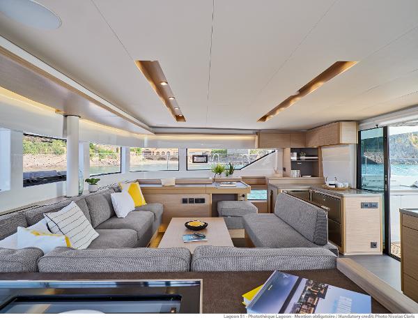 Luxurious interior of 2025 Lagoon 51 ICONIC yacht with modern furnishings and panoramic windows.