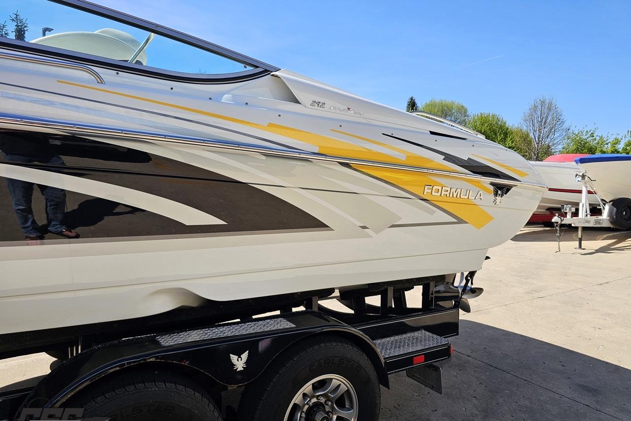 2014 Formula 292 FASTech boat with sleek design and vibrant yellow accents on trailer.