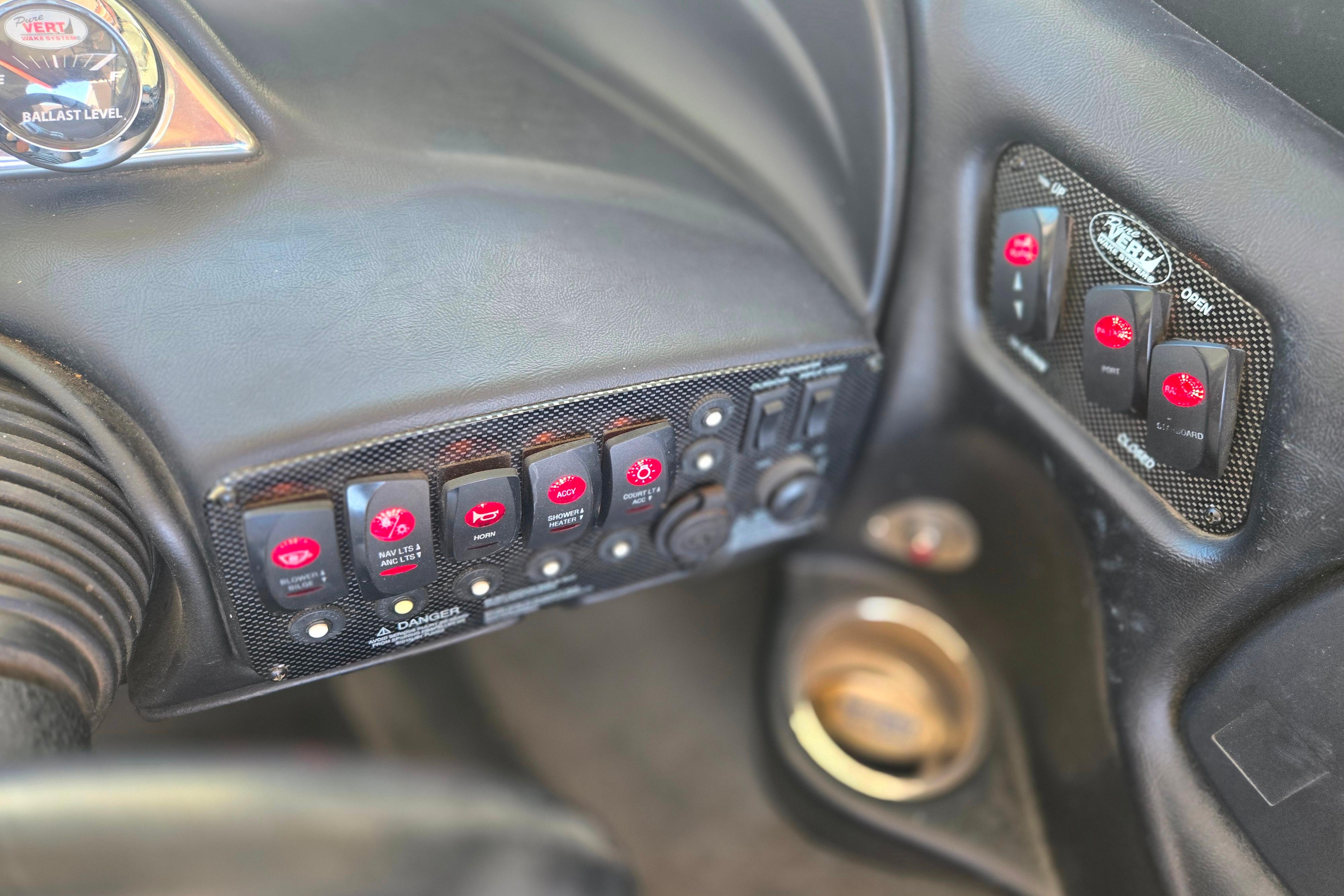 Dashboard controls of a 2007 Calabria CAL AIR PRO V boat, featuring various switches and gauges.