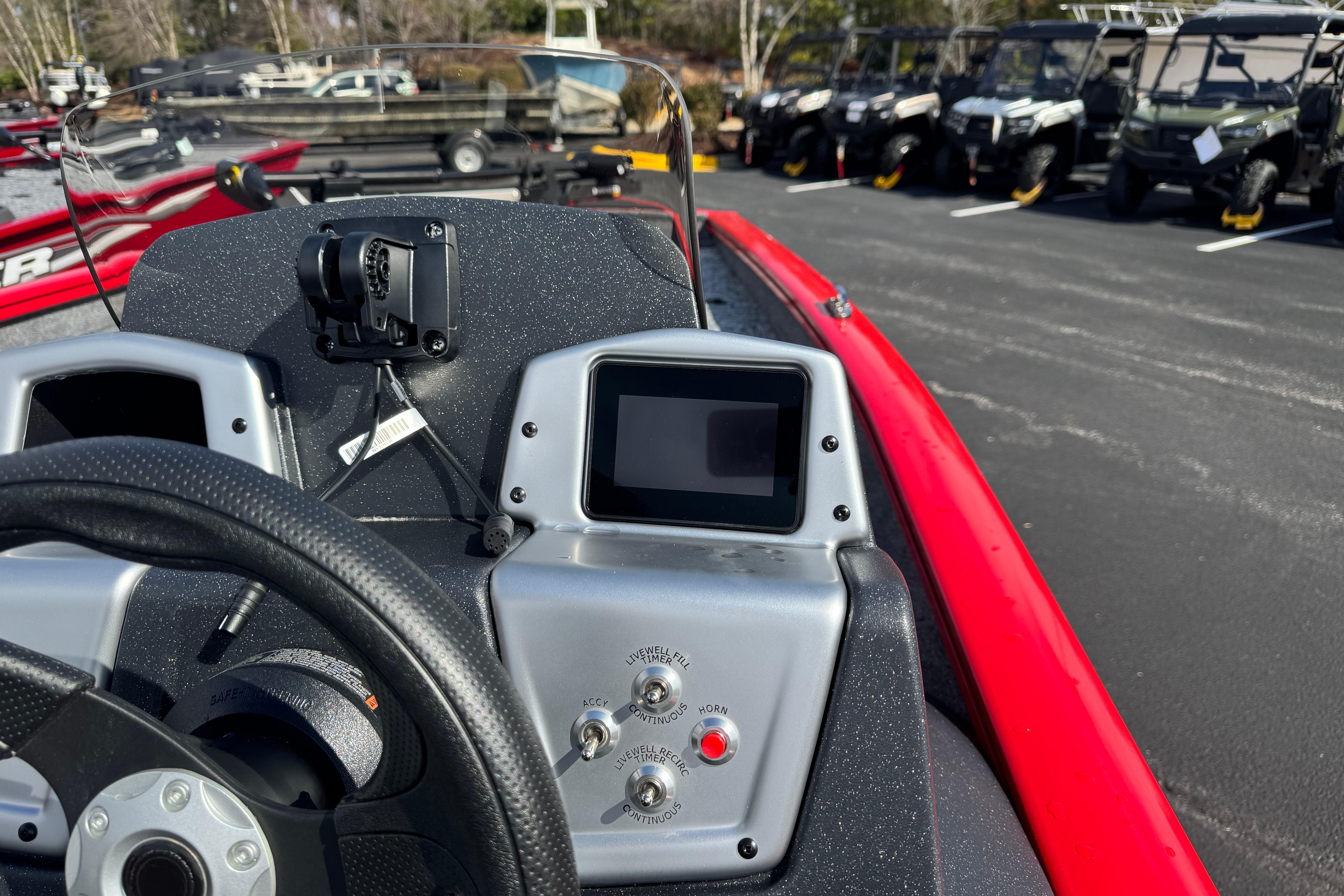 2026 Tracker Pro Team 175 boat dashboard with steering wheel and control panel.