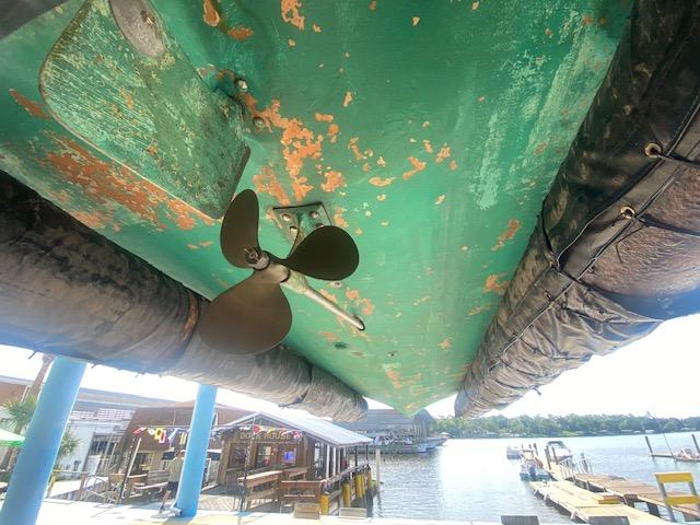Underside of 2000 Grand Craft Classic Runabout with visible propeller and weathered paint.